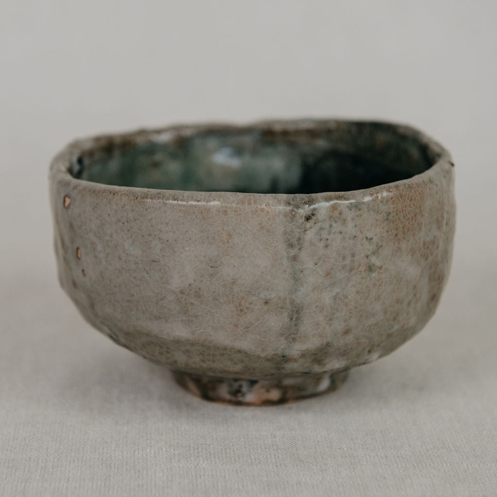 Ceramic cup with a textured surface on a plain background