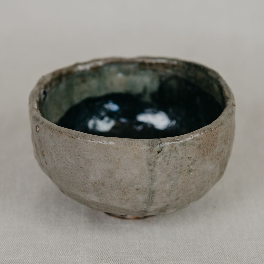 Ceramic bowl with a textured surface on a plain background