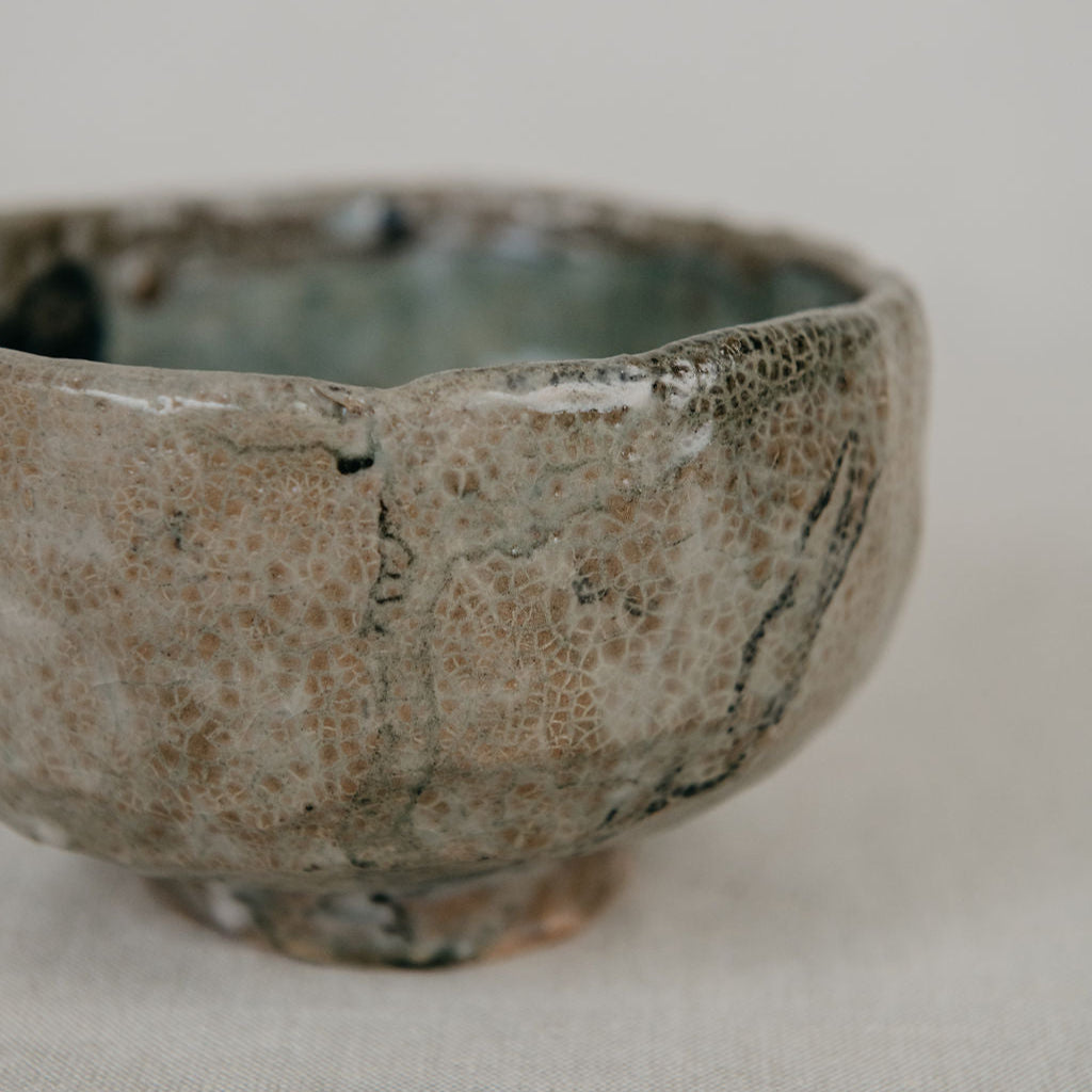 Ceramic bowl with textured surface on a plain background