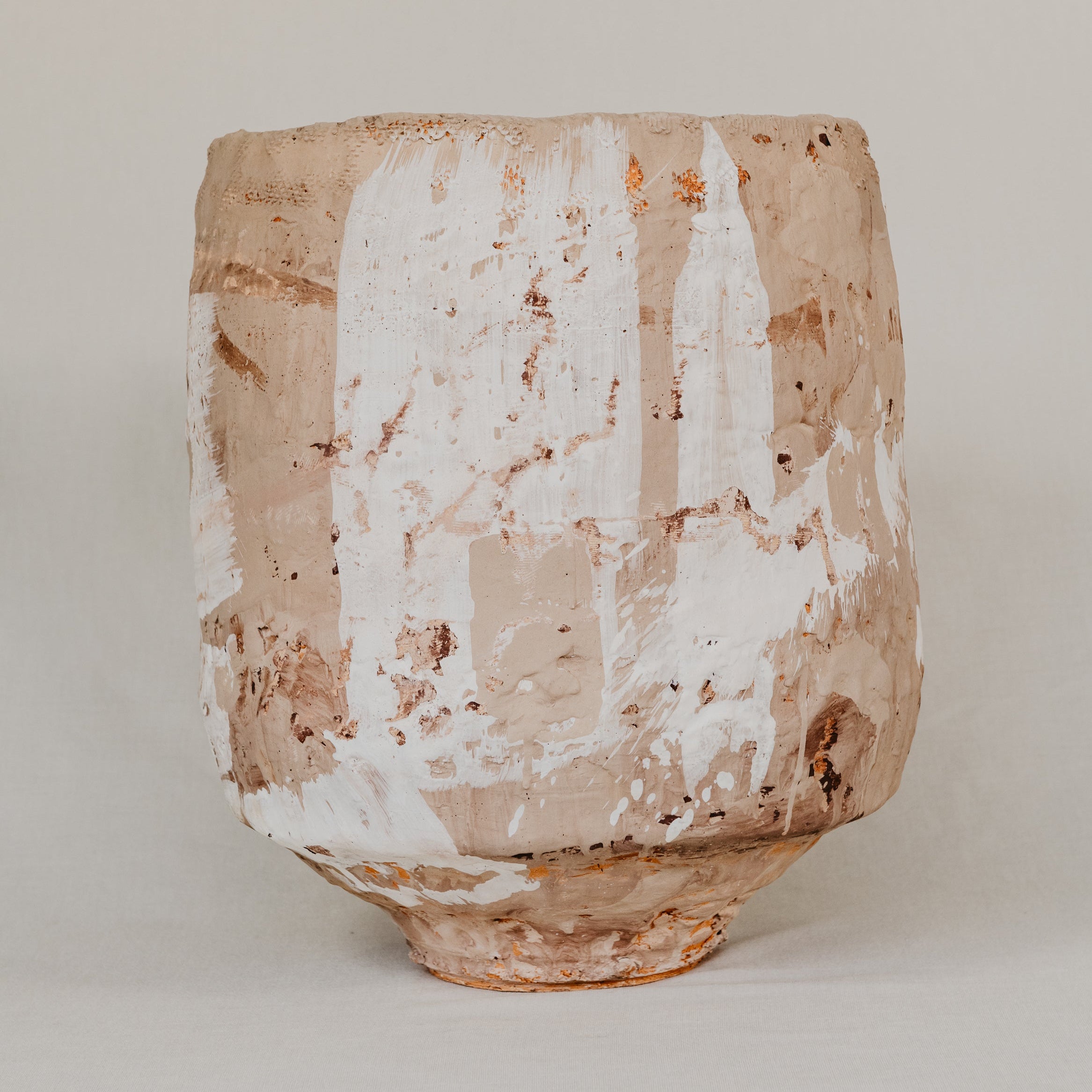 Ceramic vase with textured surface on a plain background