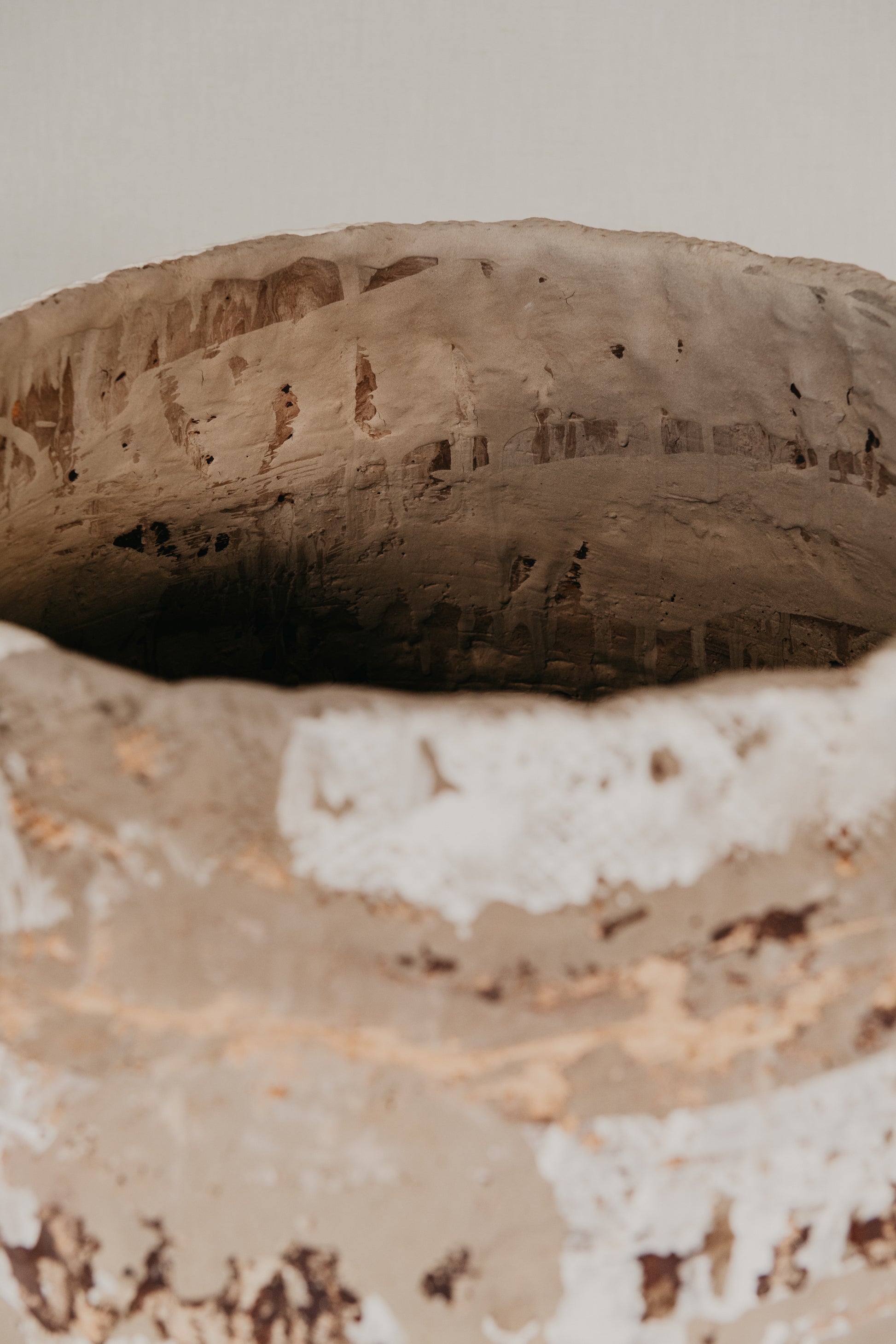 Close-up of a textured ceramic bowl with a neutral background