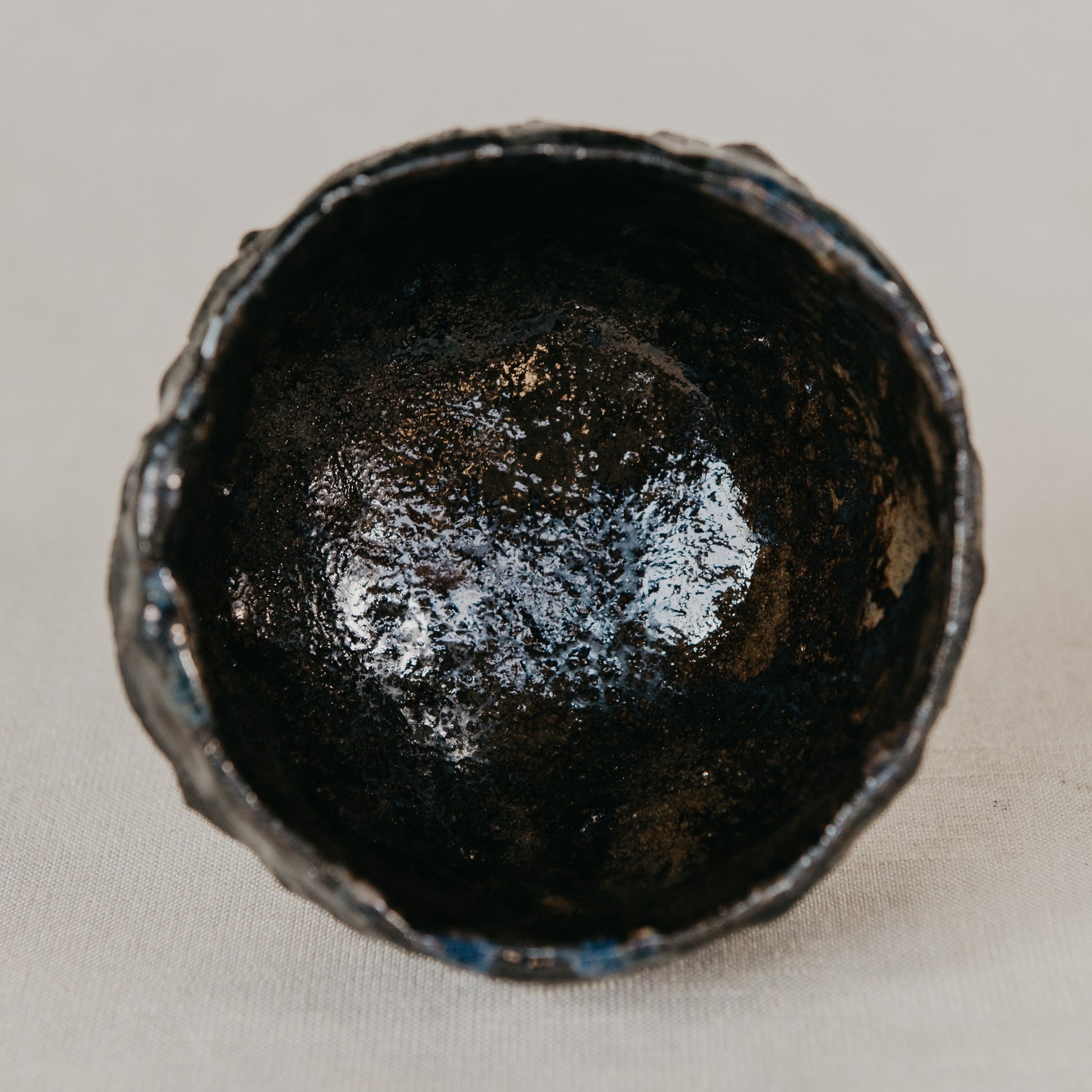 Black ceramic cup on a light gray background