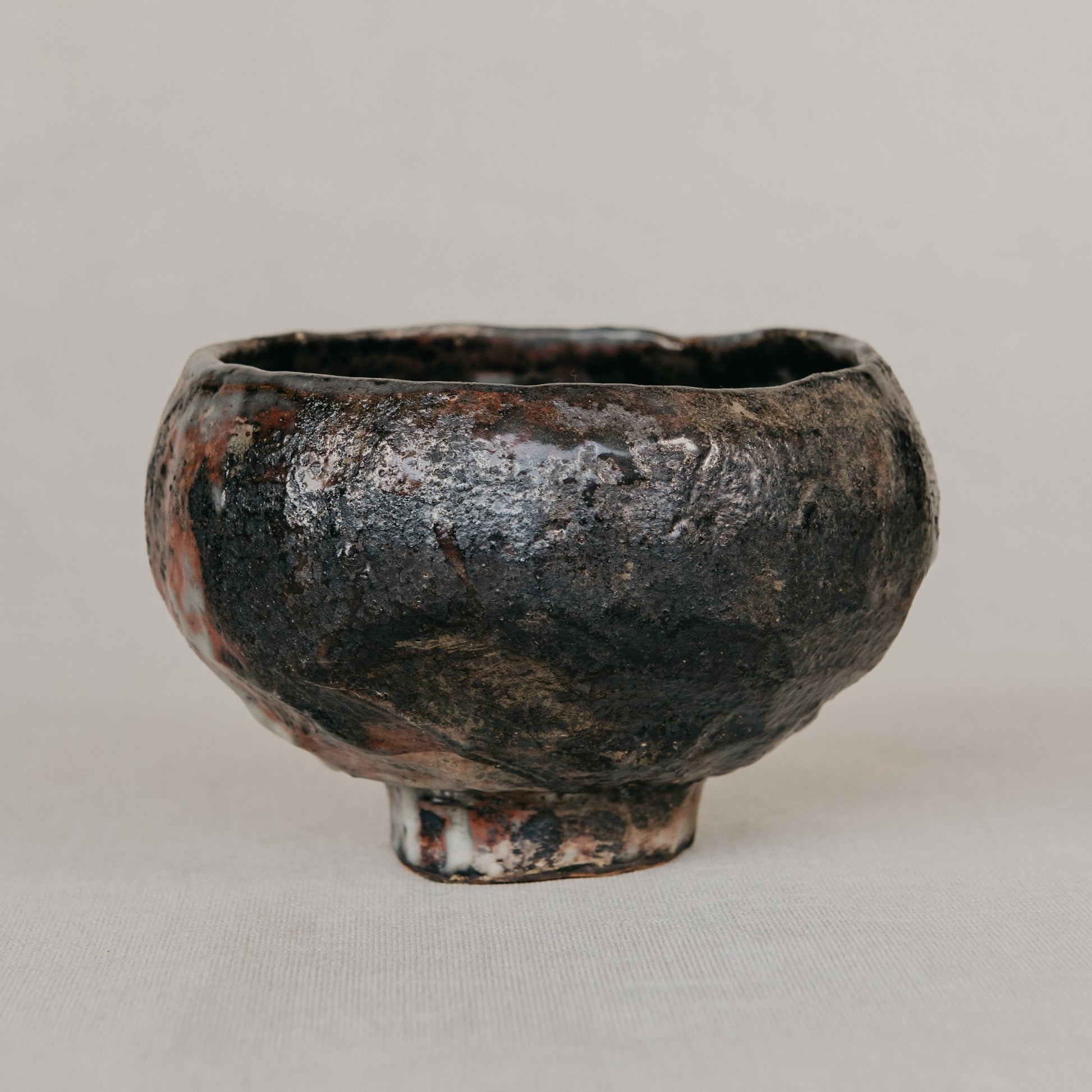 Black ceramic bowl on a light gray background