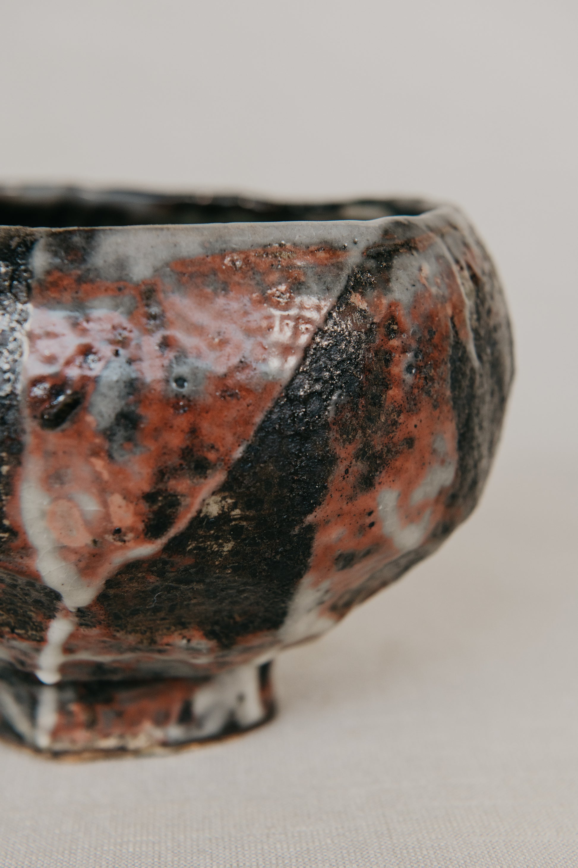 Close-up of a ceramic bowl with a textured surface on a light background