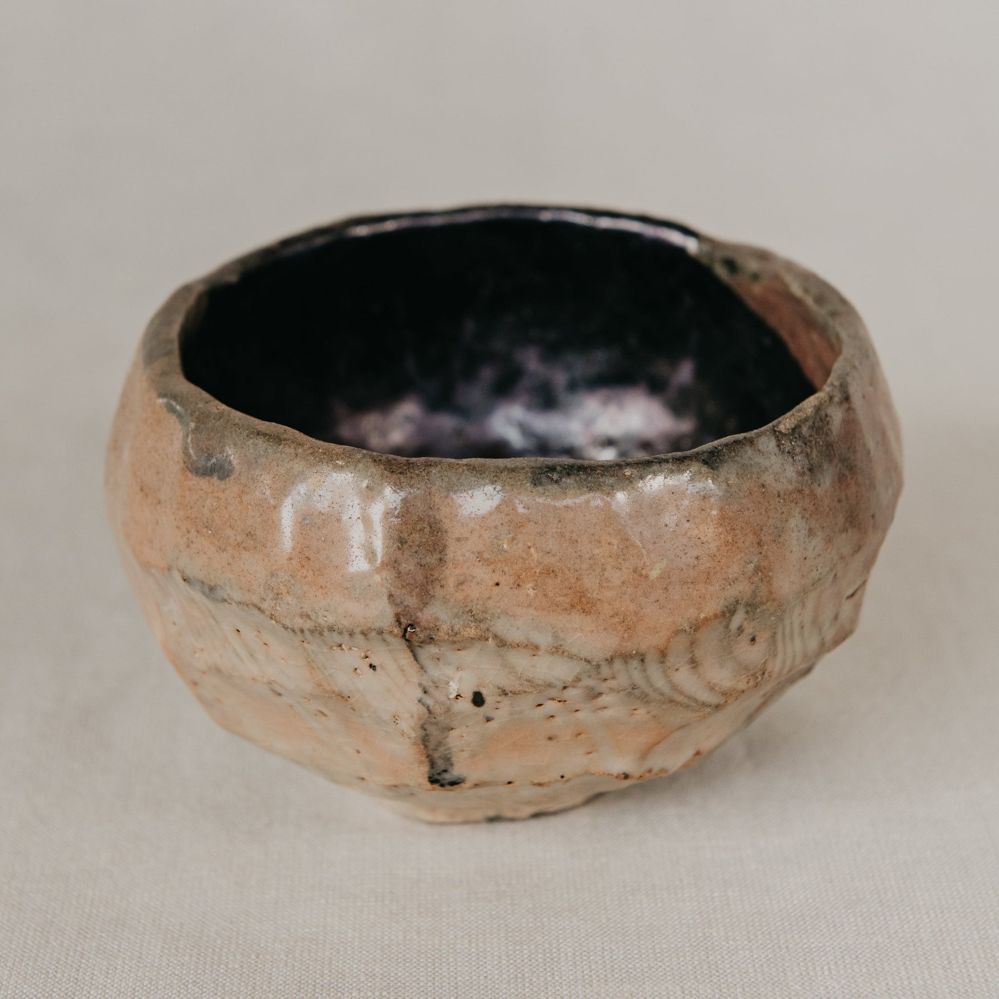 Small ceramic bowl with a textured surface on a neutral background