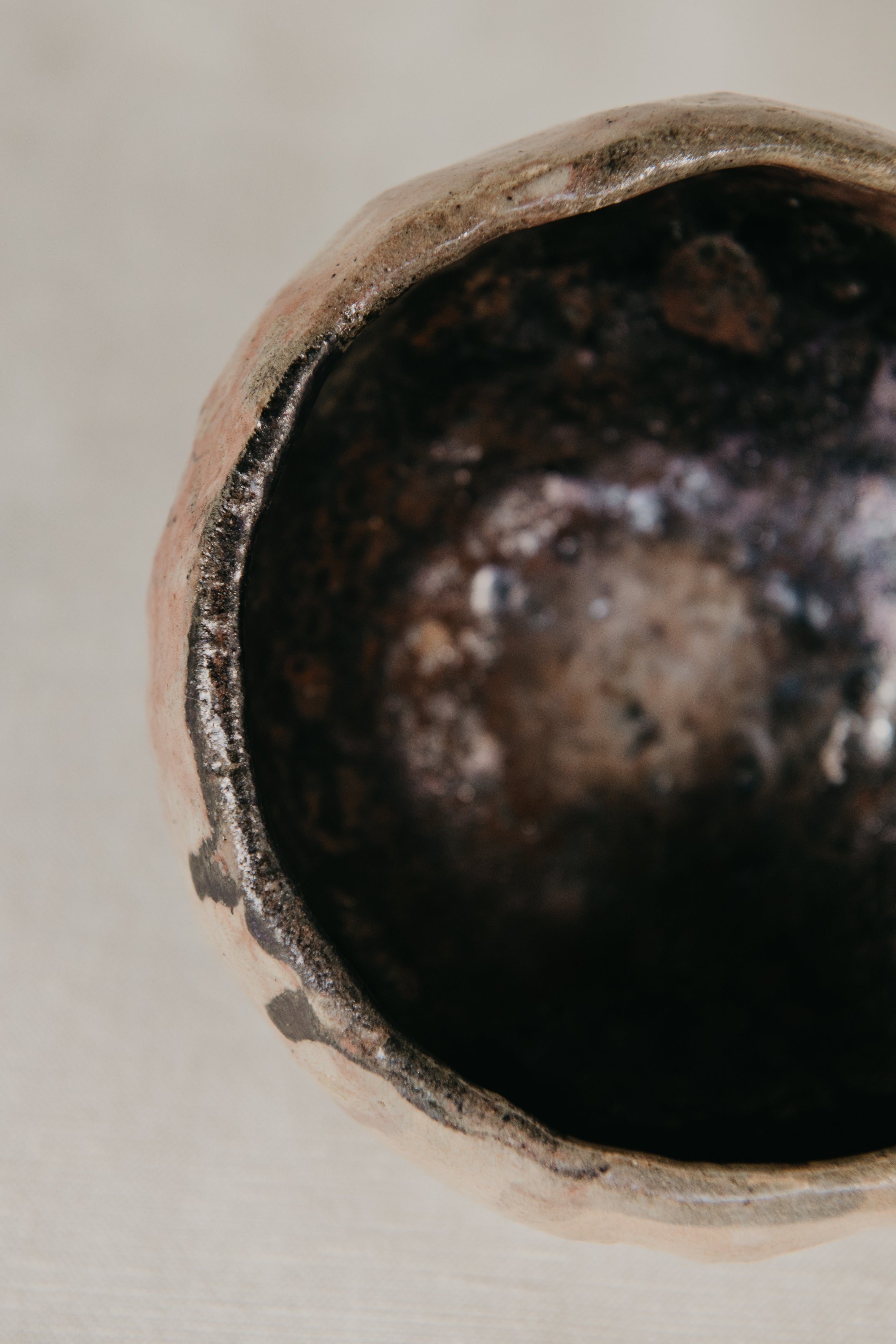 Close-up of a textured ceramic bowl with a neutral background