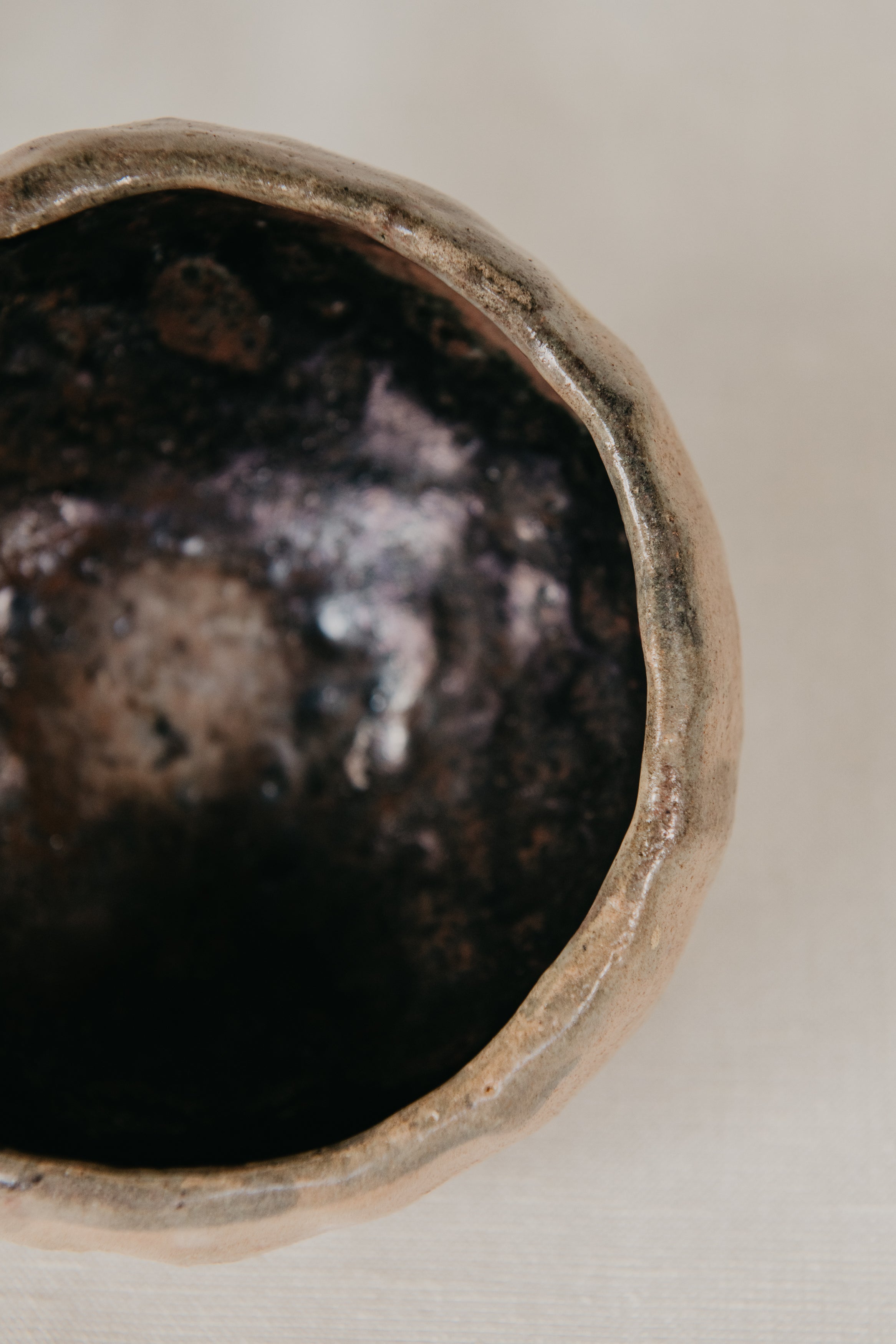Close-up of a textured ceramic bowl on a neutral background
