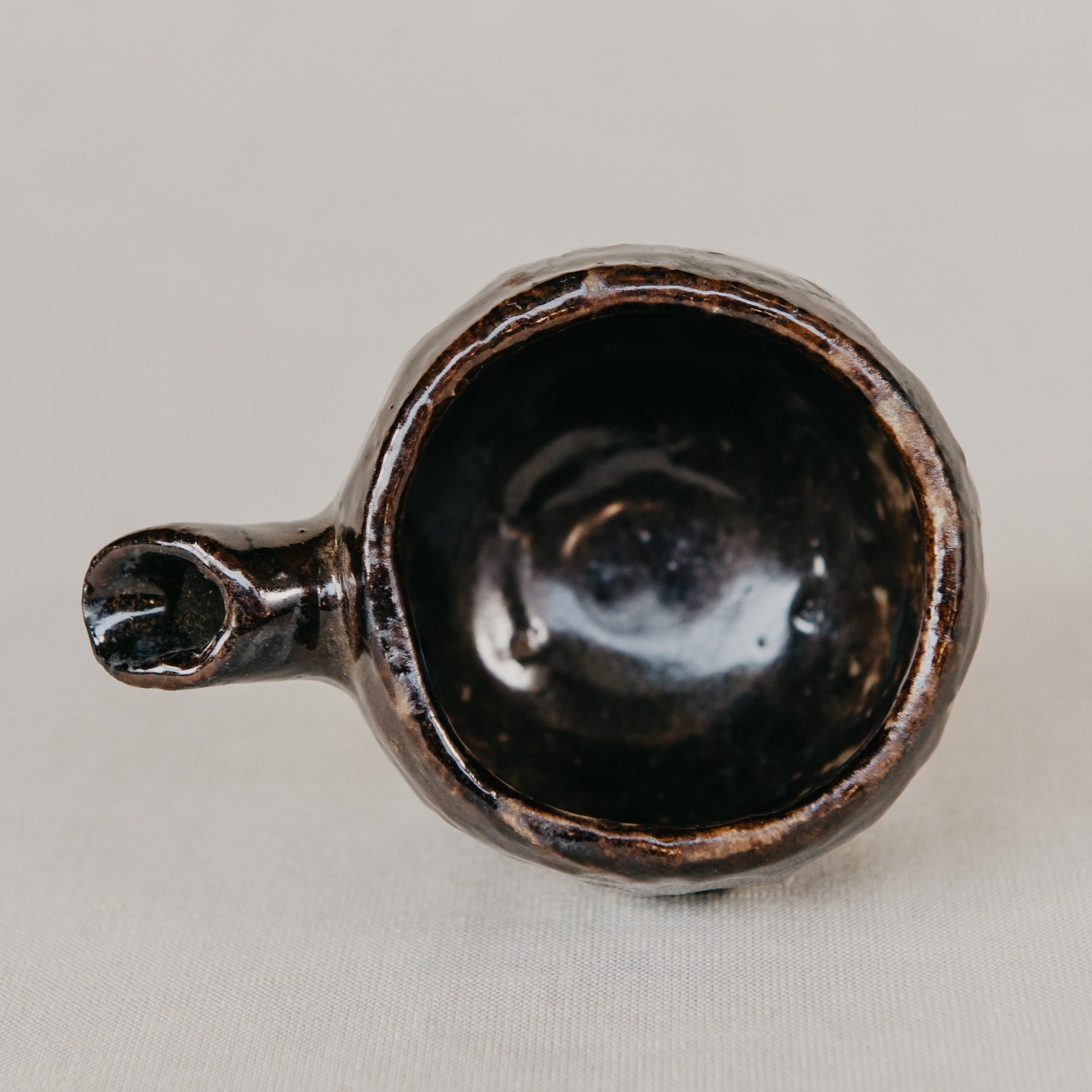 Black ceramic scoop on a light gray background