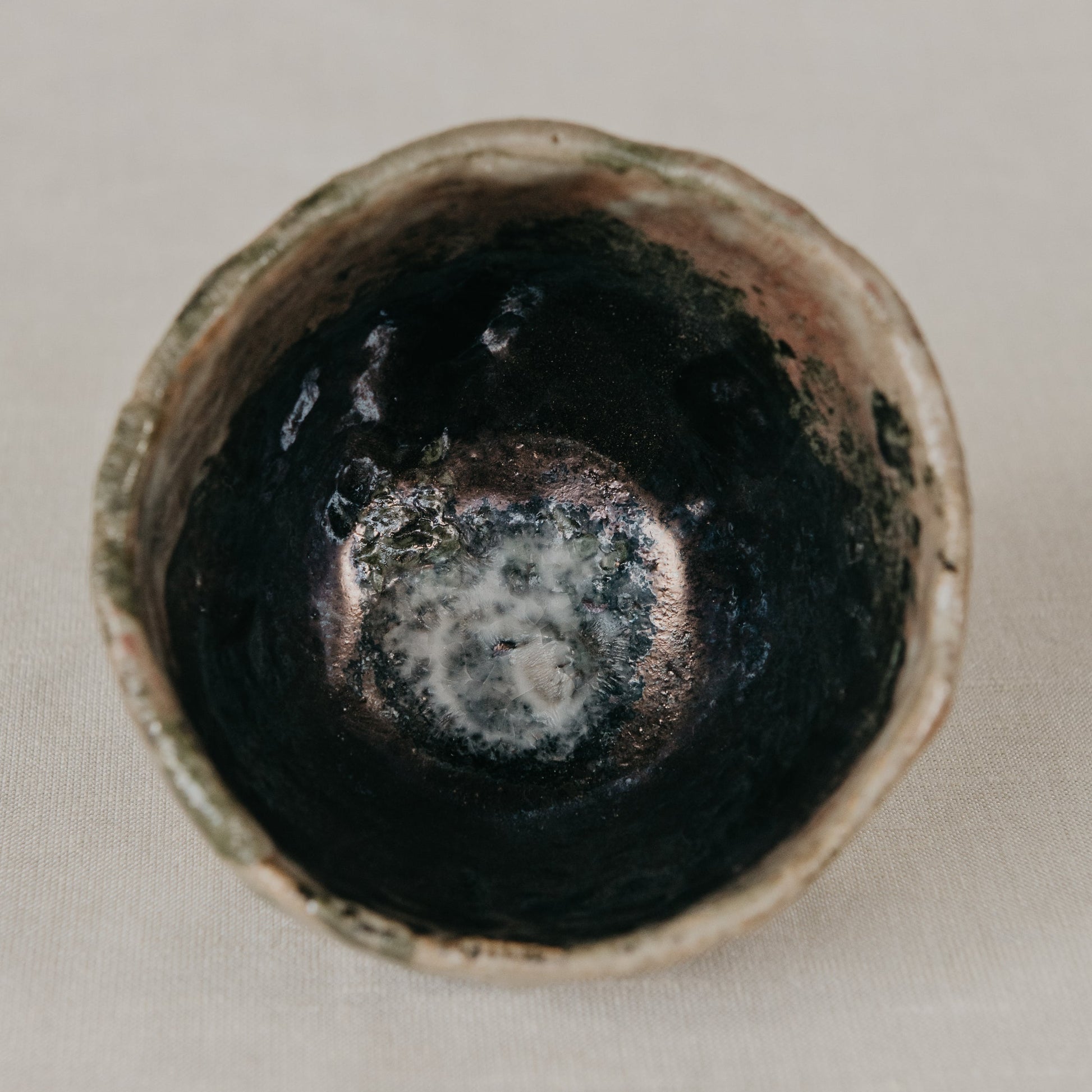 Ceramic cup with a dark interior on a light background