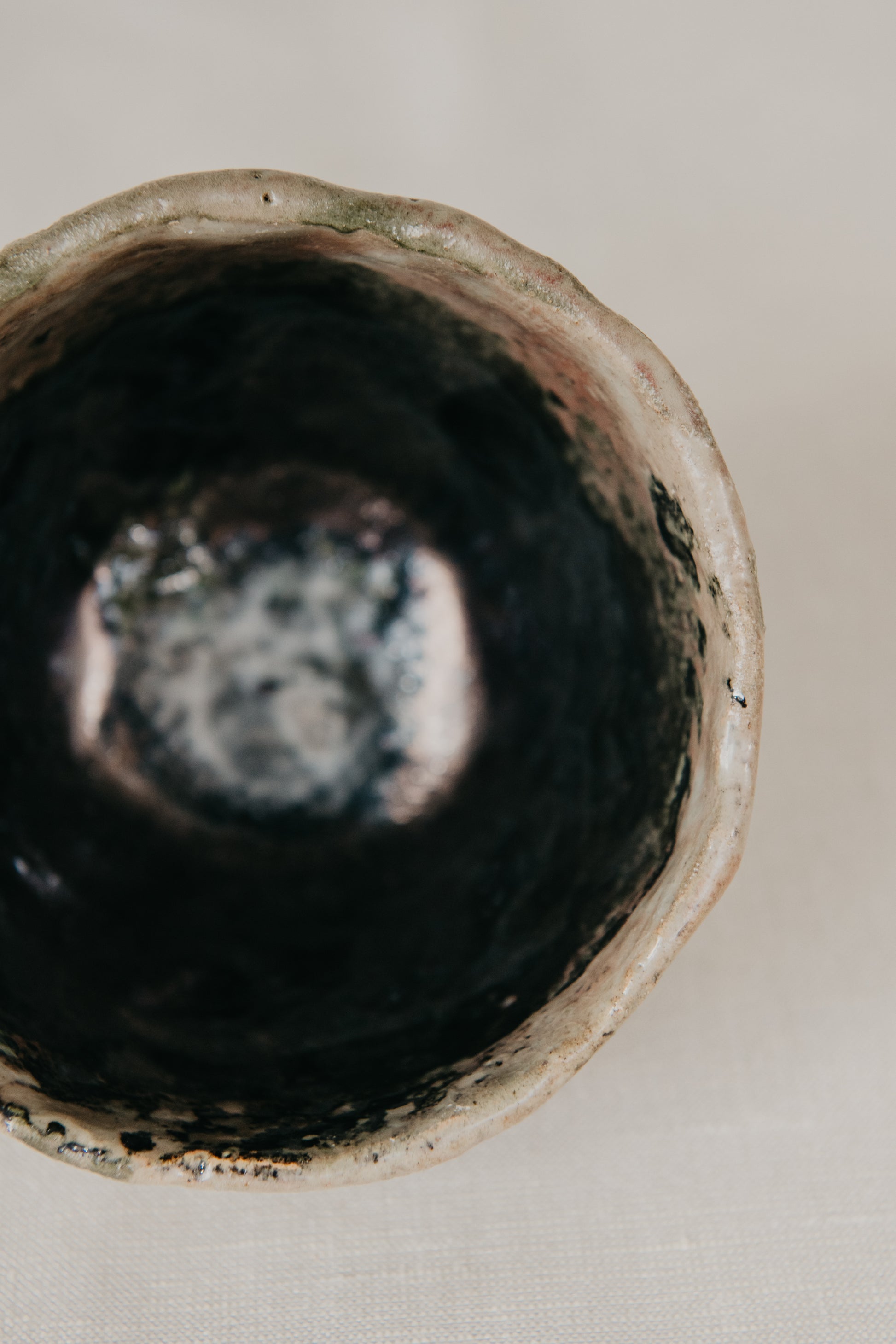 Close-up of a ceramic bowl with a textured surface on a neutral background