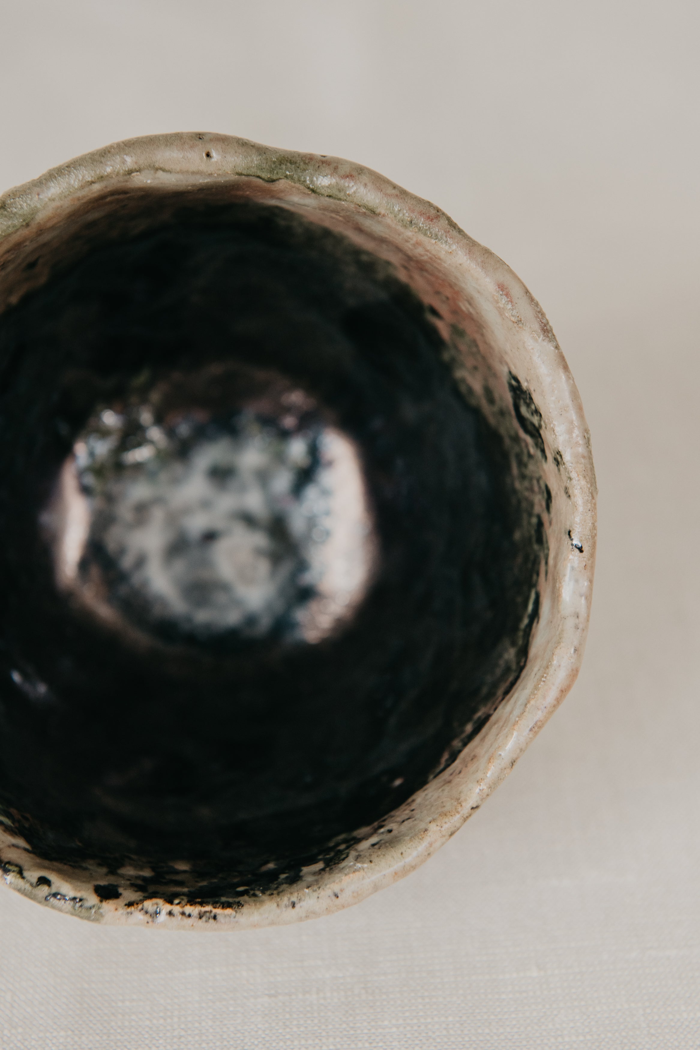 Close-up of a ceramic bowl with a textured surface on a neutral background