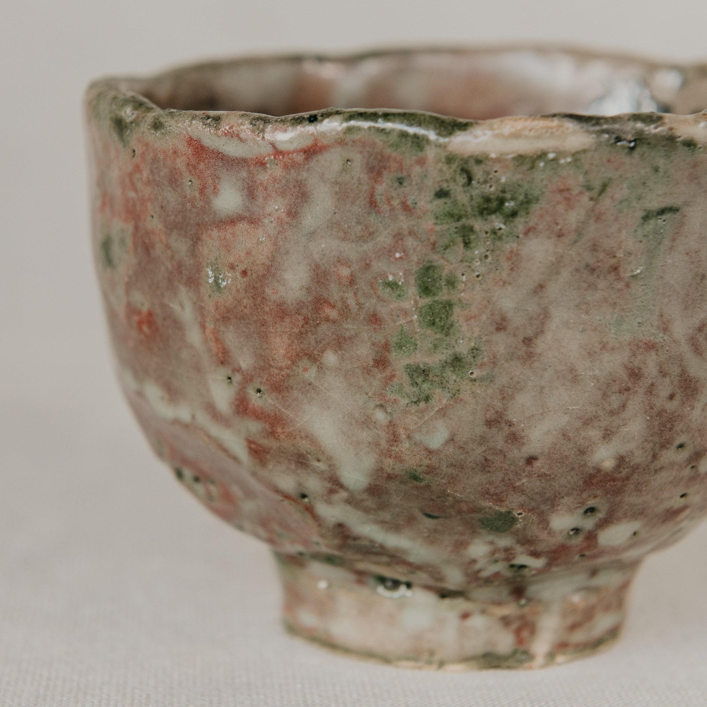 Vintage ceramic cup with a textured surface on a plain background