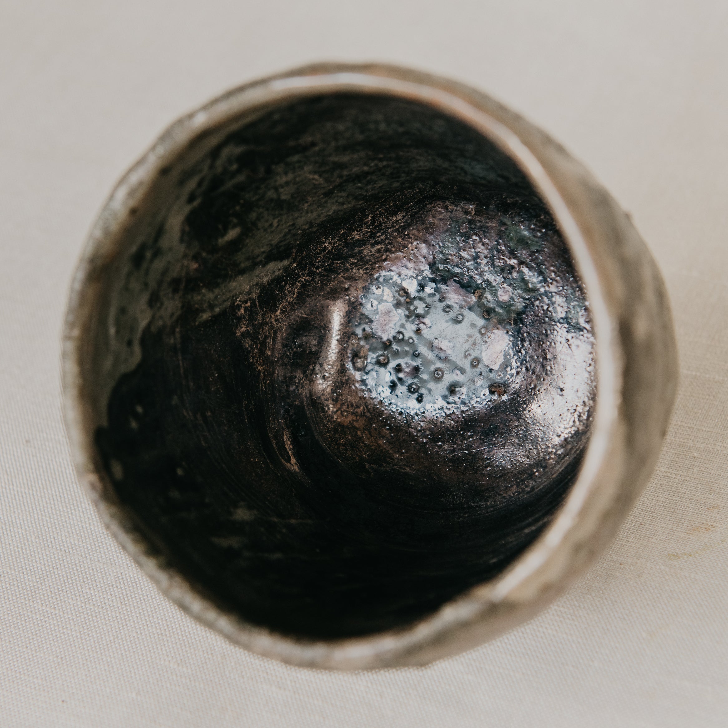 Close-up of a textured ceramic vase on a neutral background