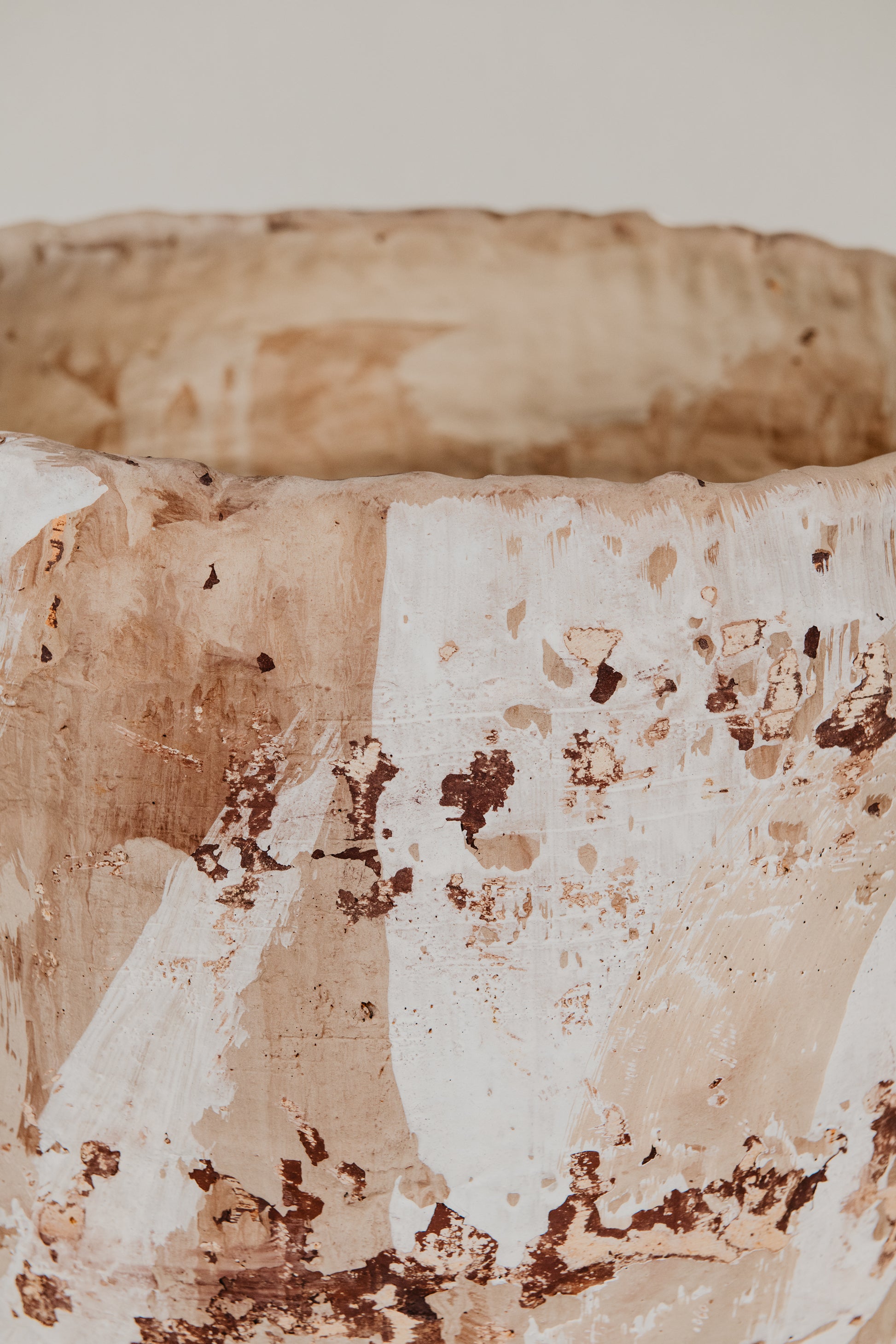 Close-up of a textured ceramic bowl with a neutral color palette