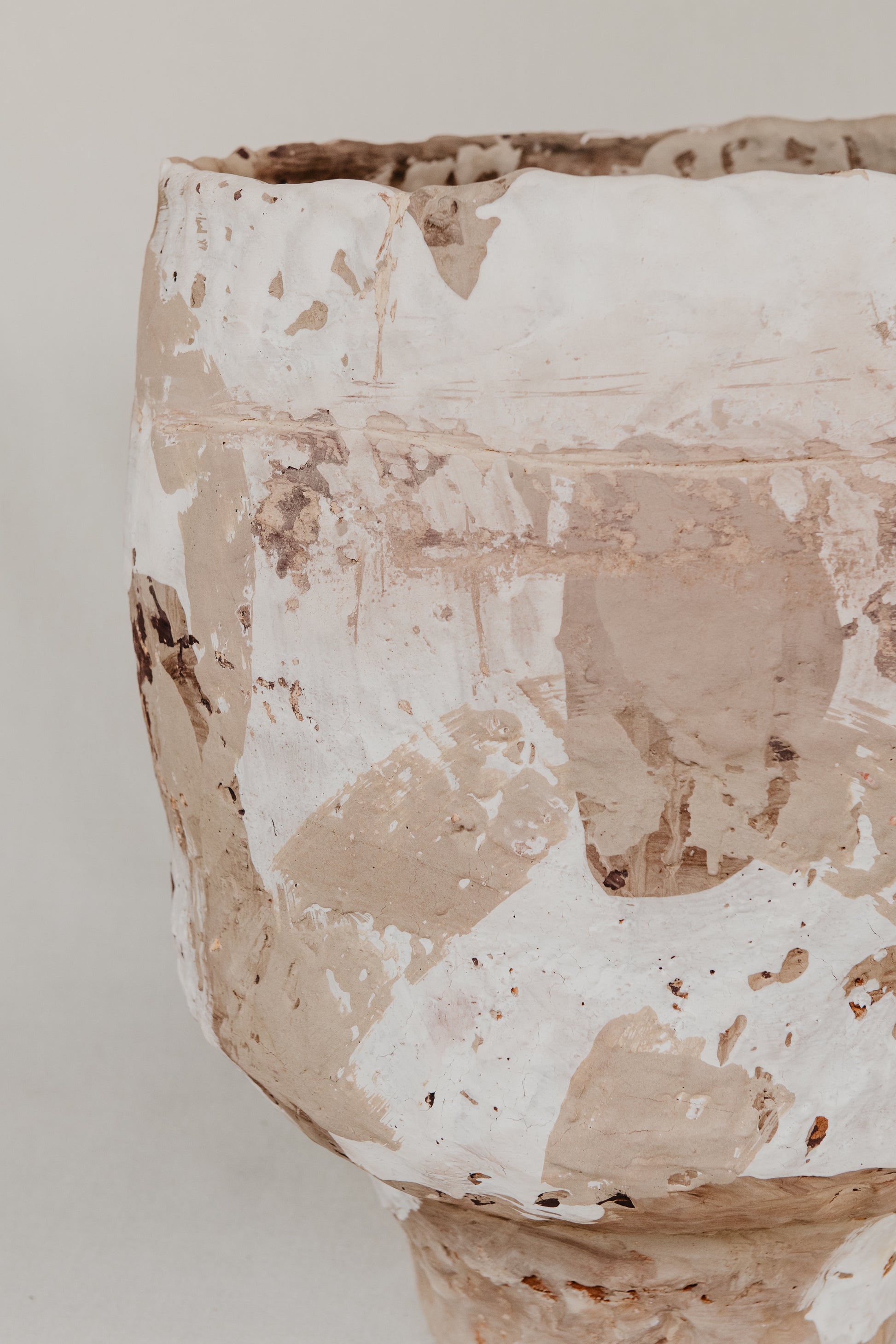 Close-up of a textured ceramic vase on a light background