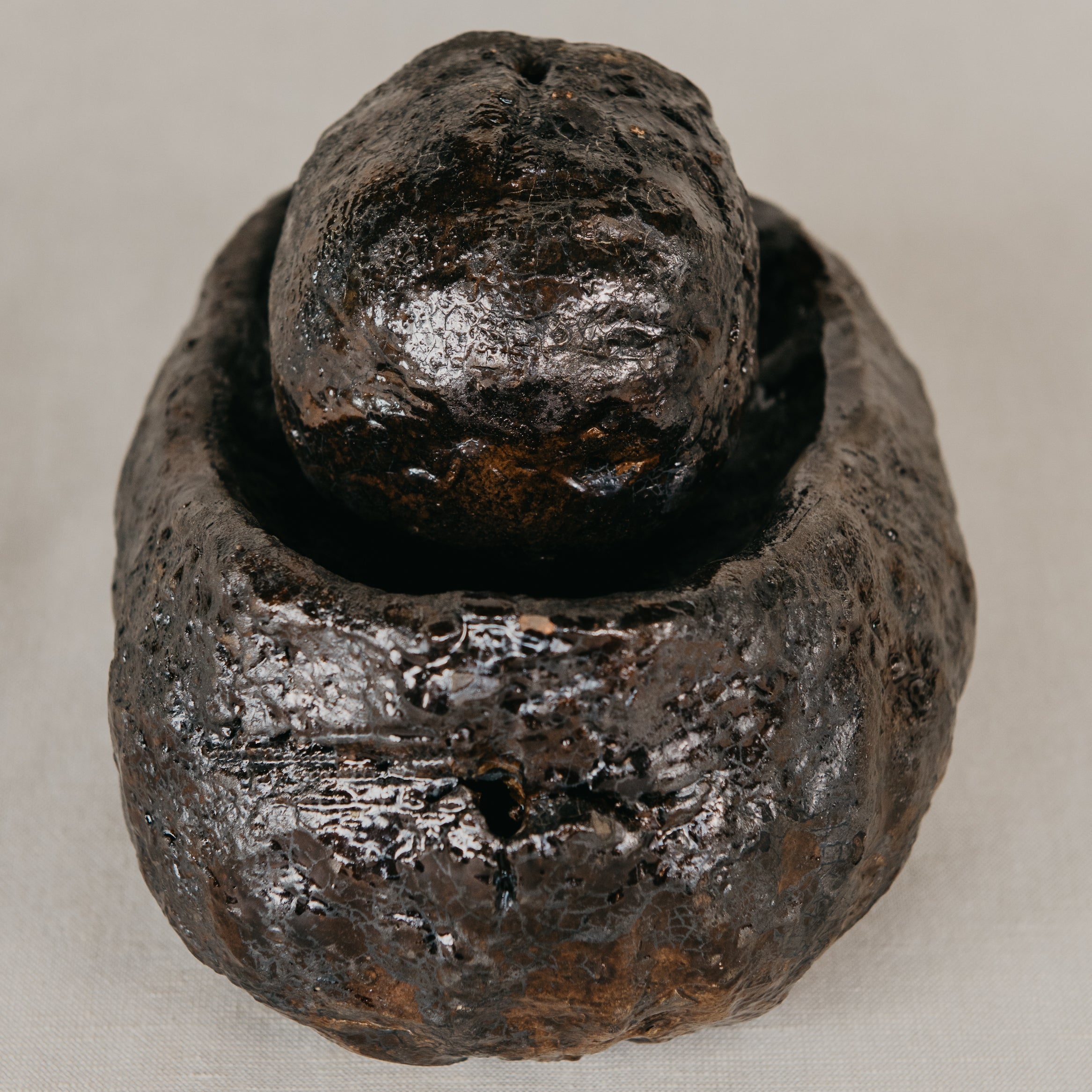 Rustic ceramic object on a neutral background