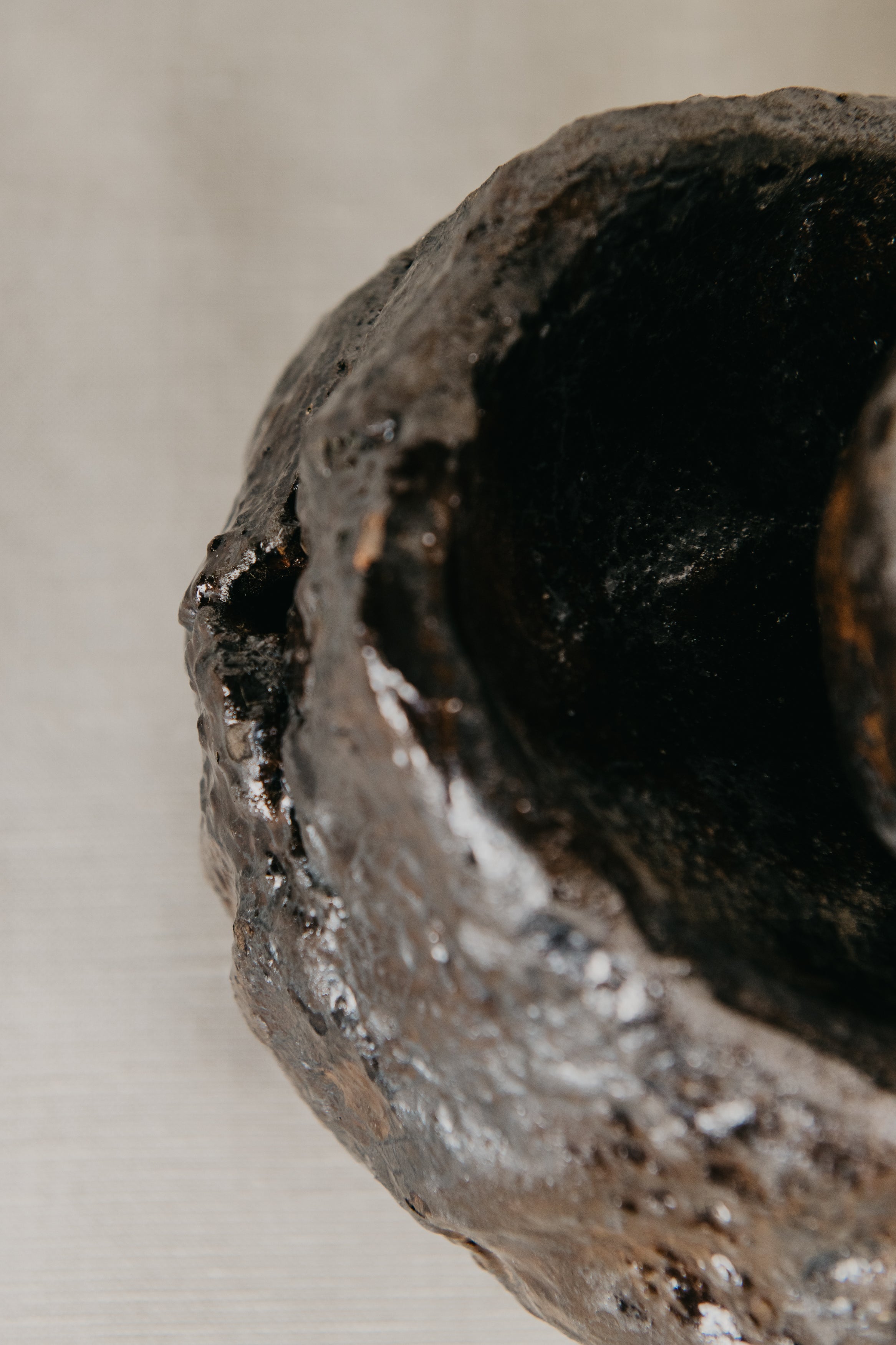 Close-up of a worn ceramic object with a blurred background