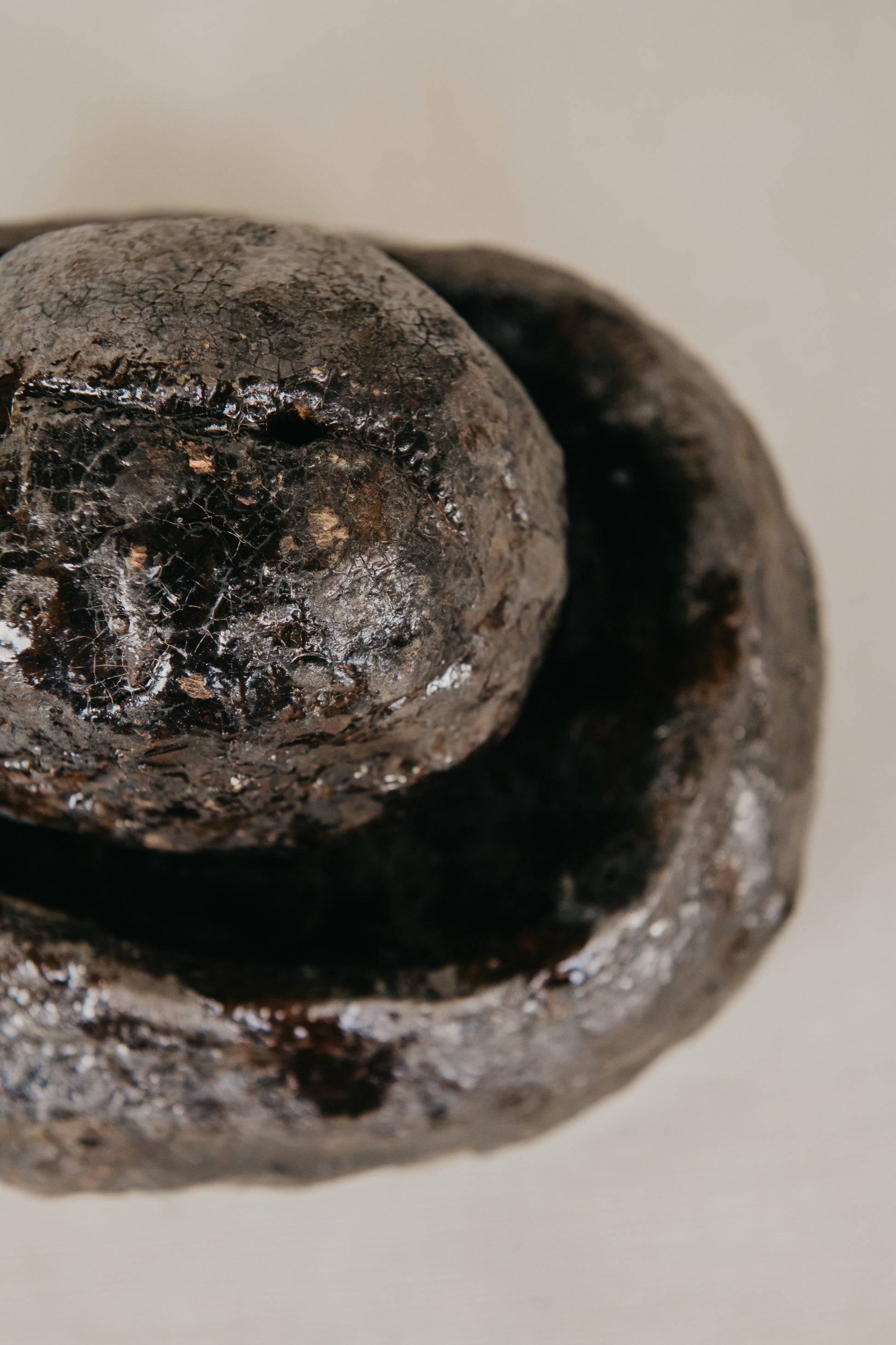 Close-up of a worn ceramic object with a textured surface.