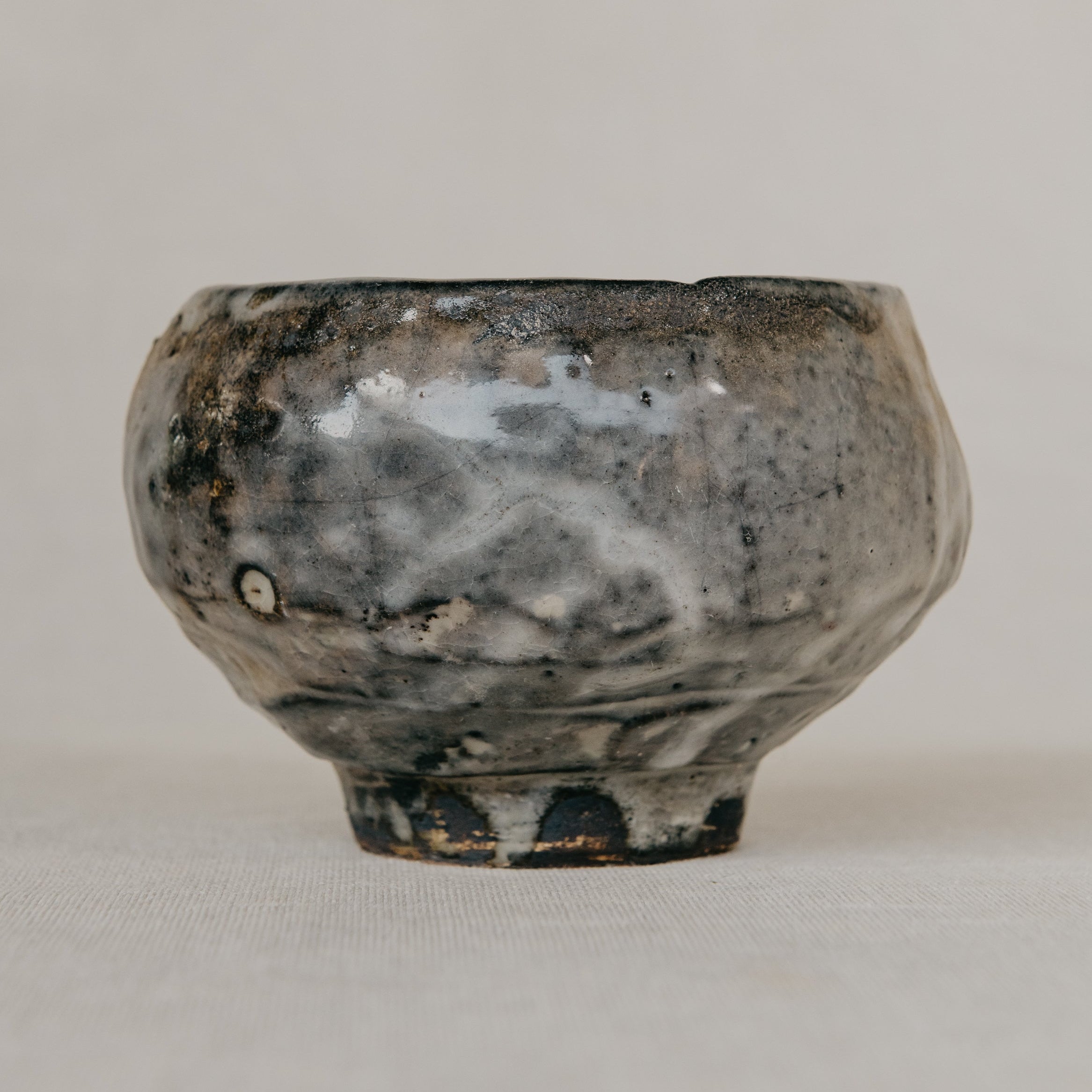 Vintage ceramic bowl with a textured surface on a plain background