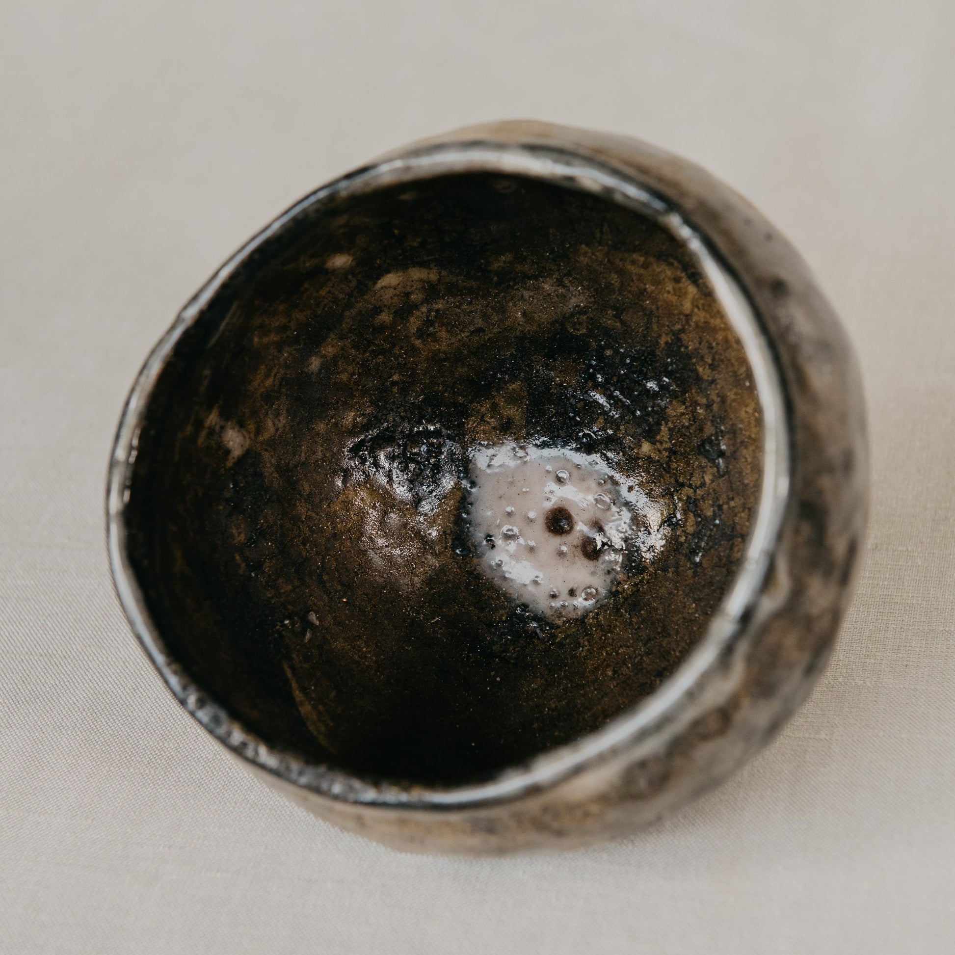 Ceramic cup with a textured interior on a light gray background