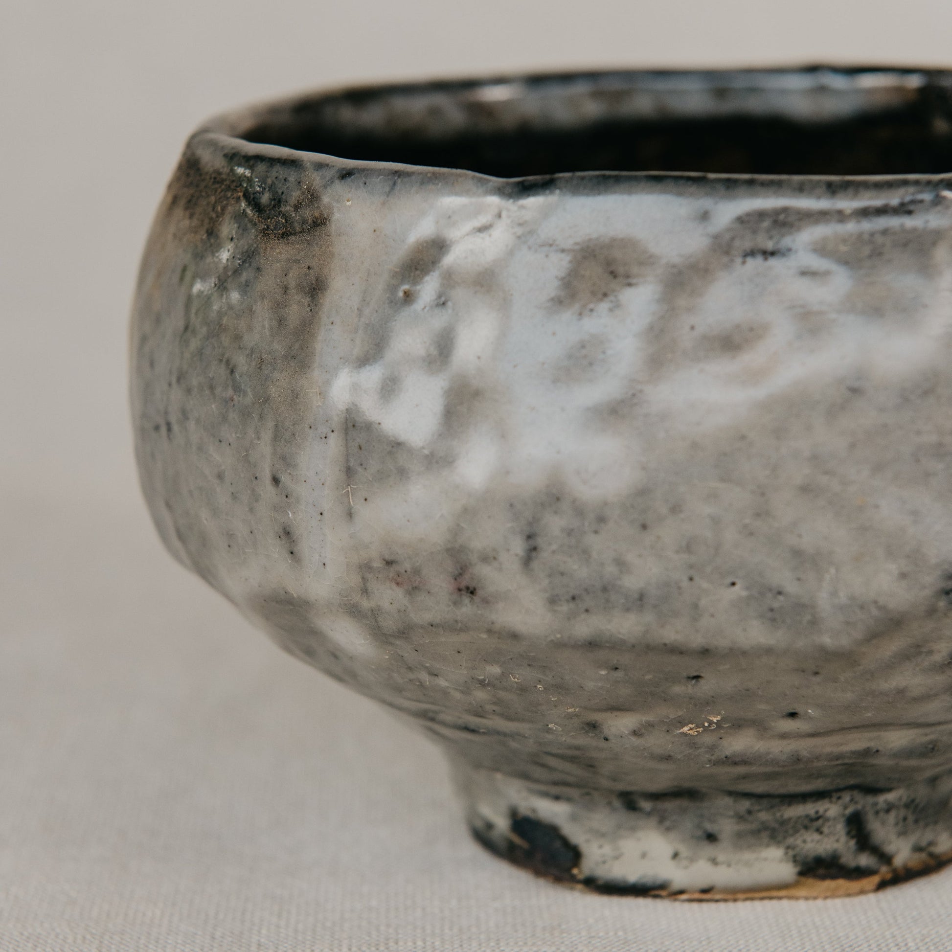 Stoneware bowl with a textured surface on a light gray background