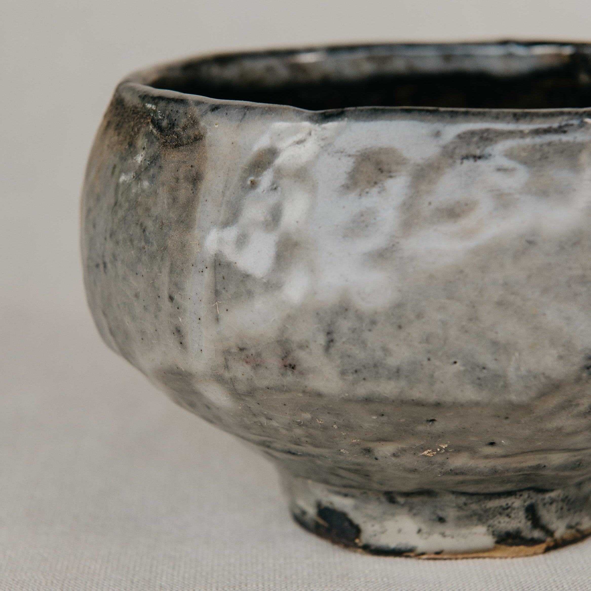Stoneware bowl with a textured surface on a light gray background