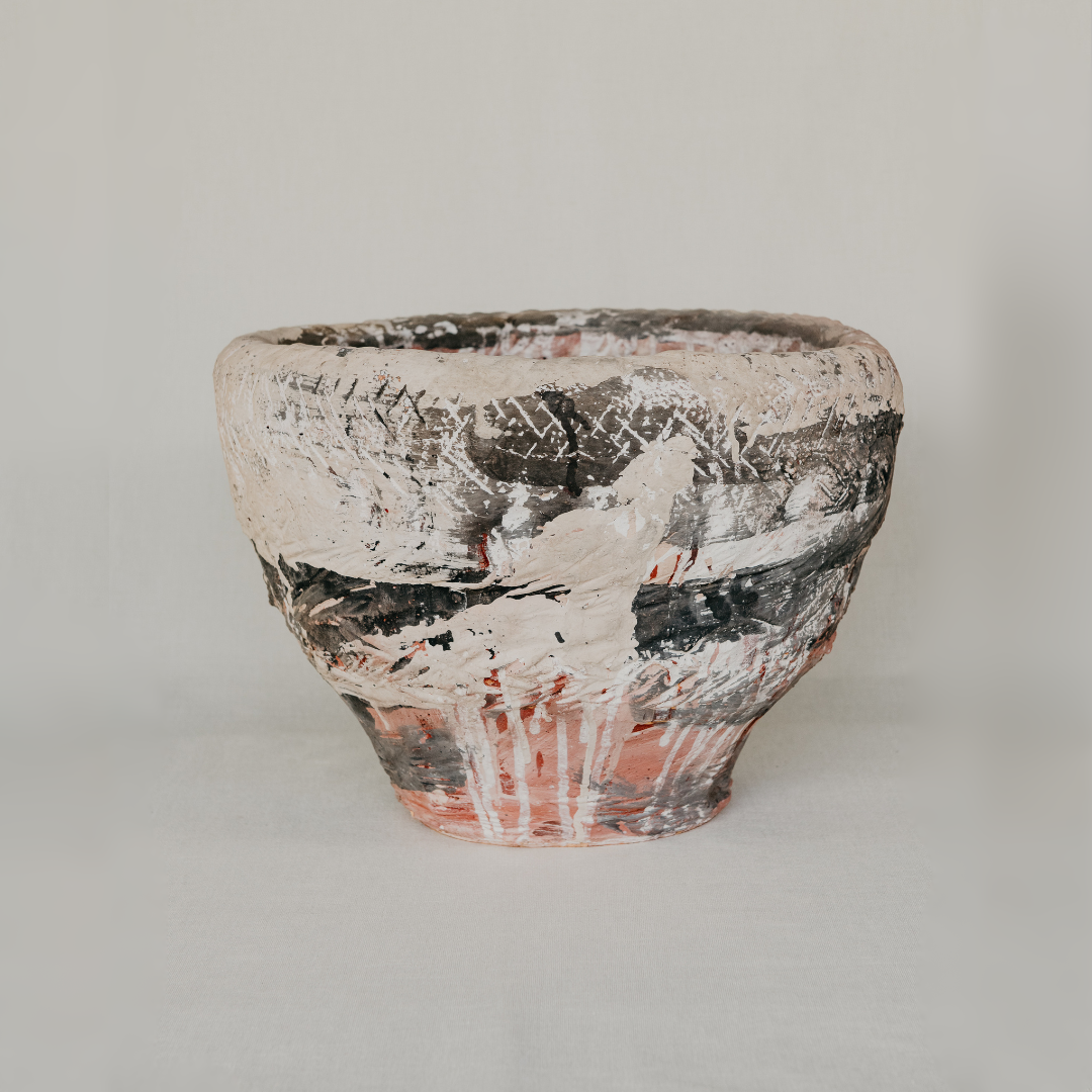 Ceramic pot with textured surface on a plain background