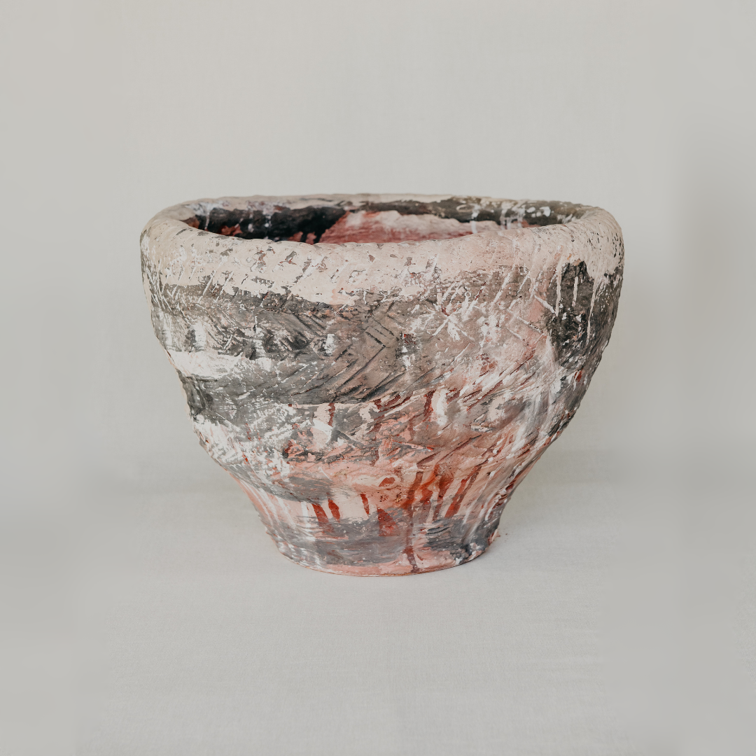 White ceramic pot with speckled texture on a light gray background