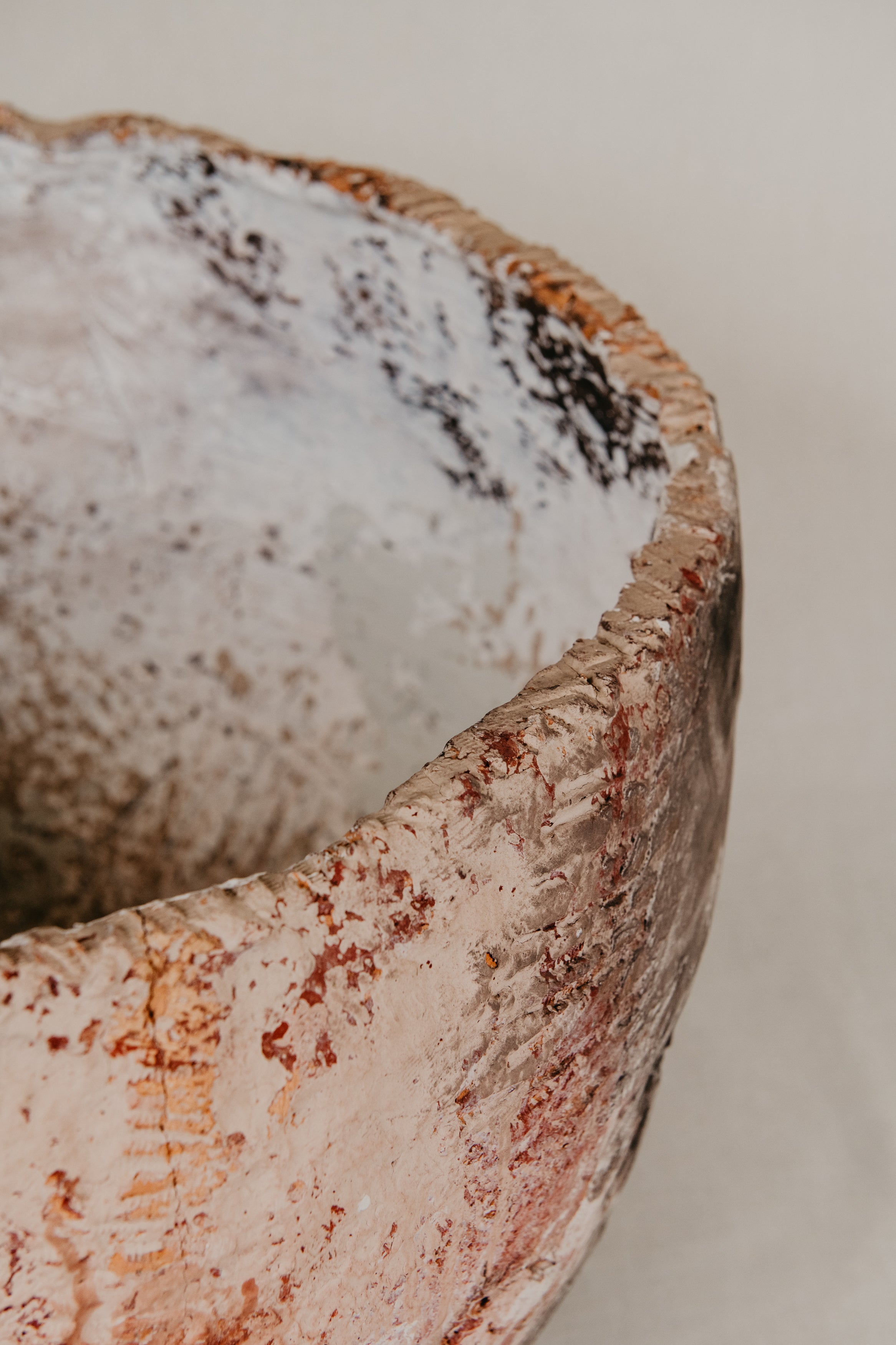 Close-up of a textured ceramic bowl with a neutral background