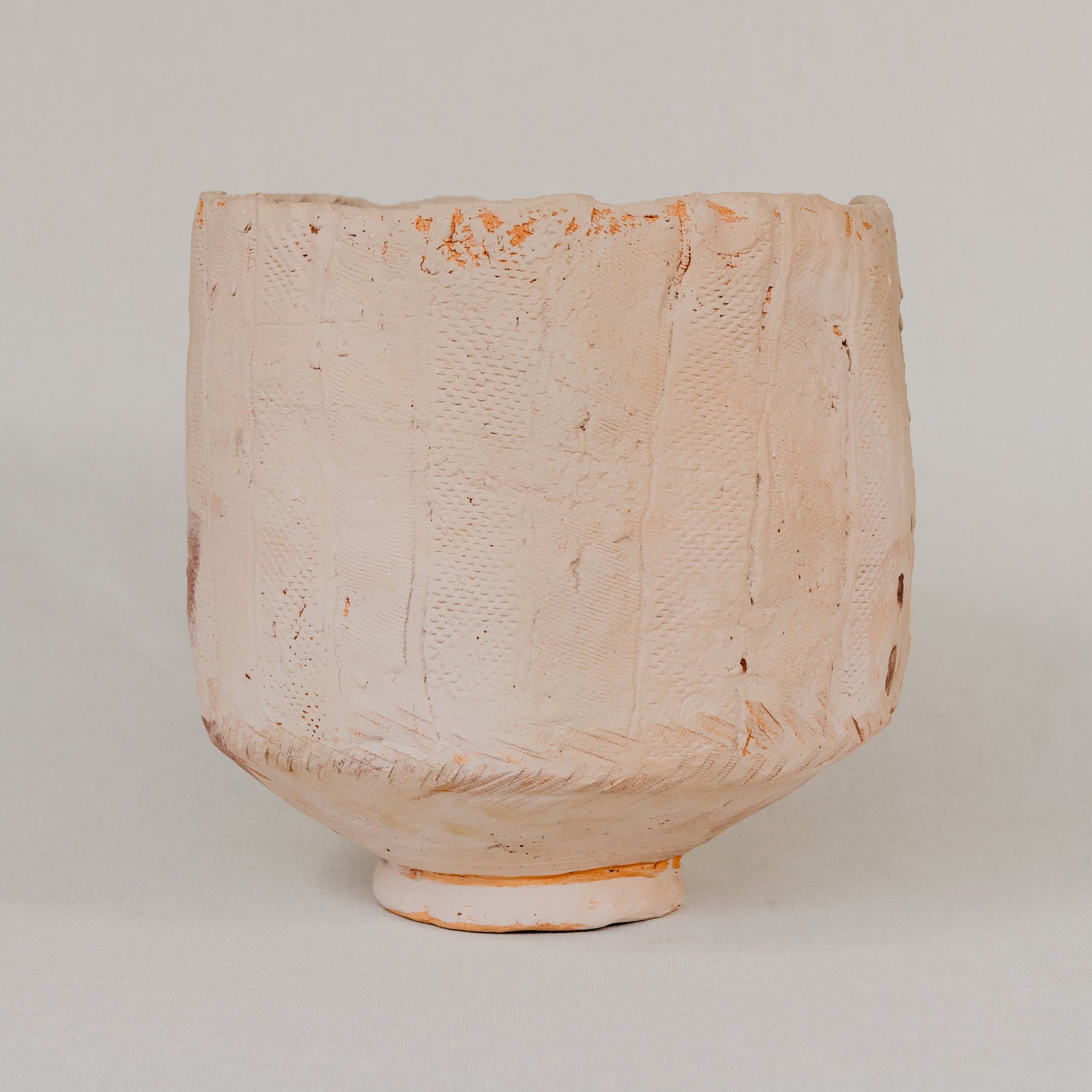 Textured ceramic vase on a plain background