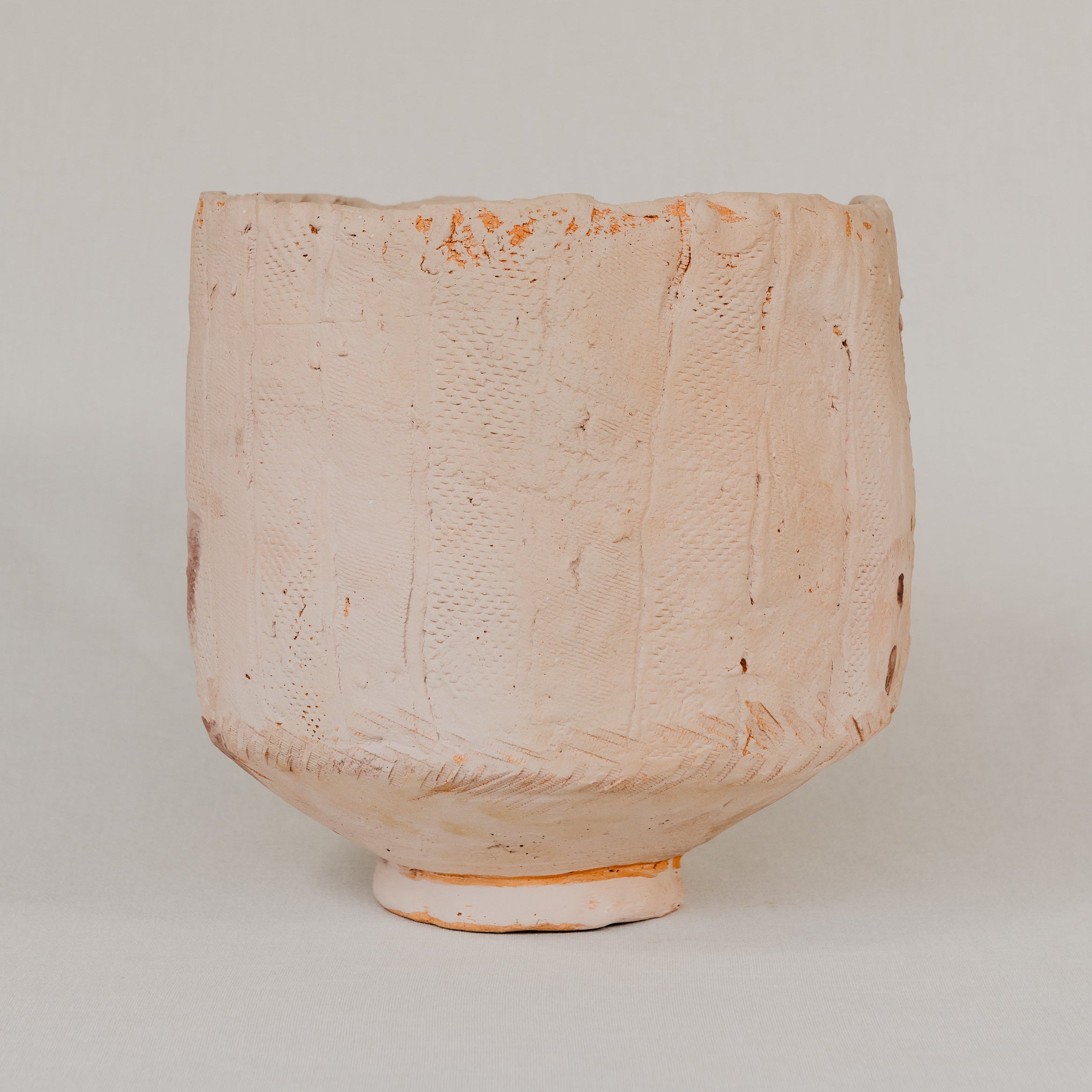 Textured ceramic vase on a plain background