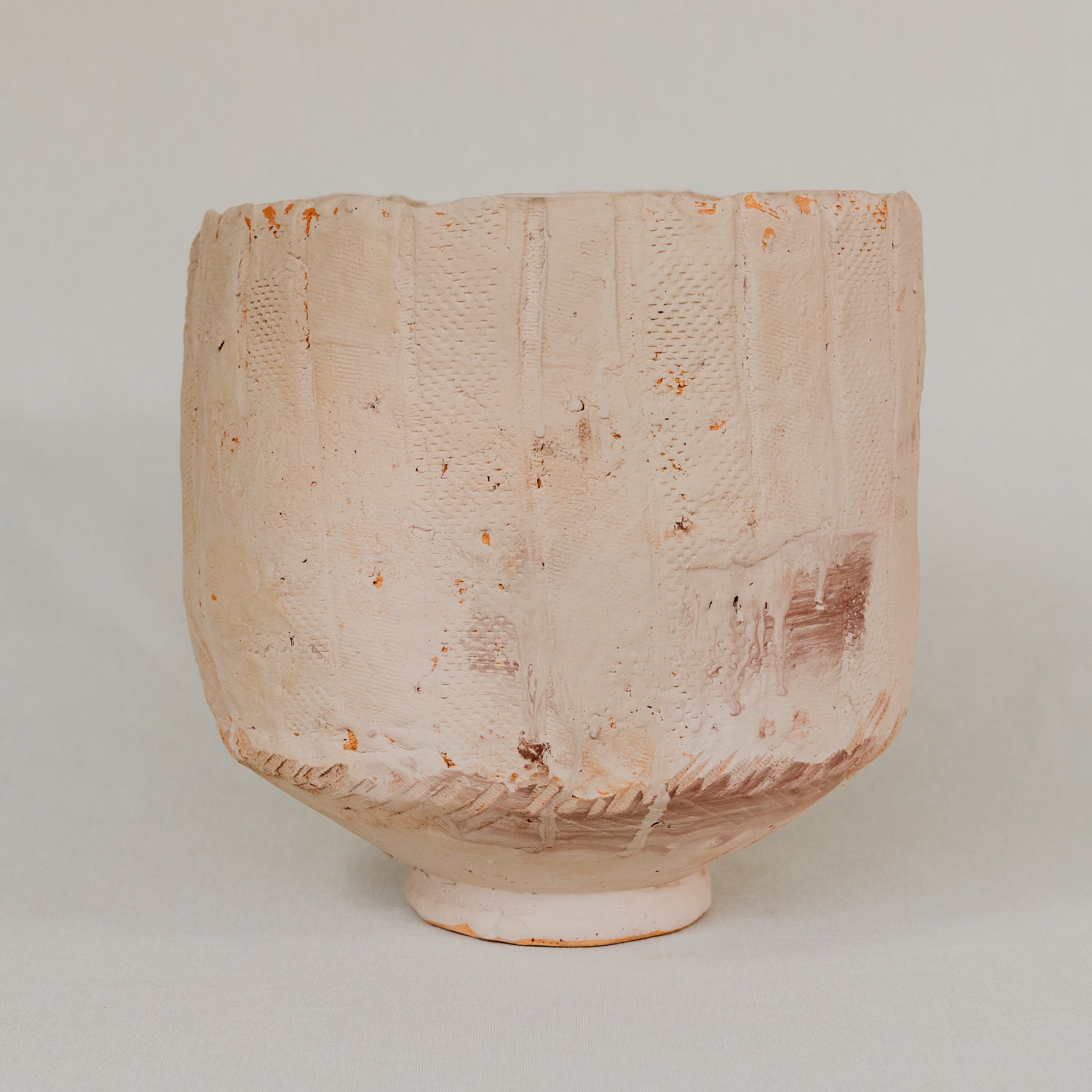 Textured ceramic vase on a plain background
