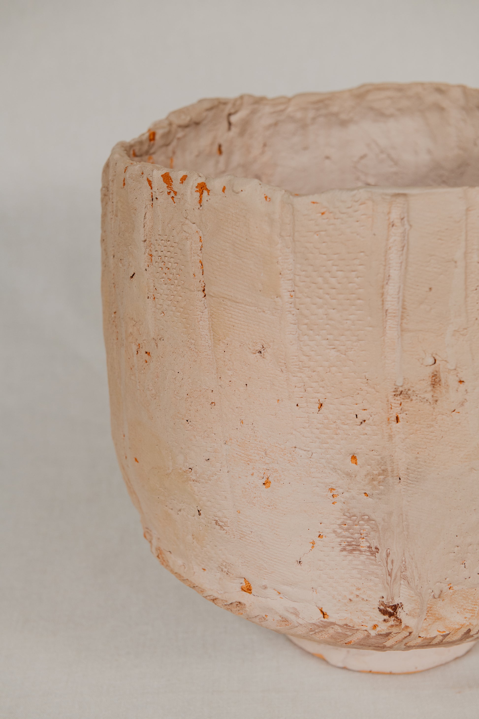 Close-up of a textured ceramic bowl on a plain background