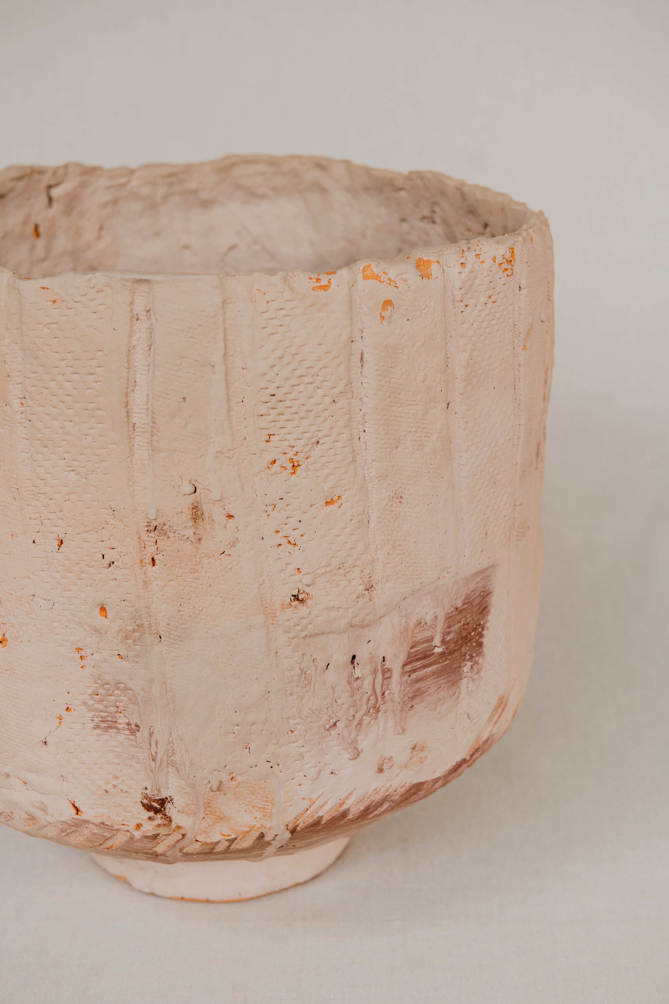 Textured ceramic pot on a plain background