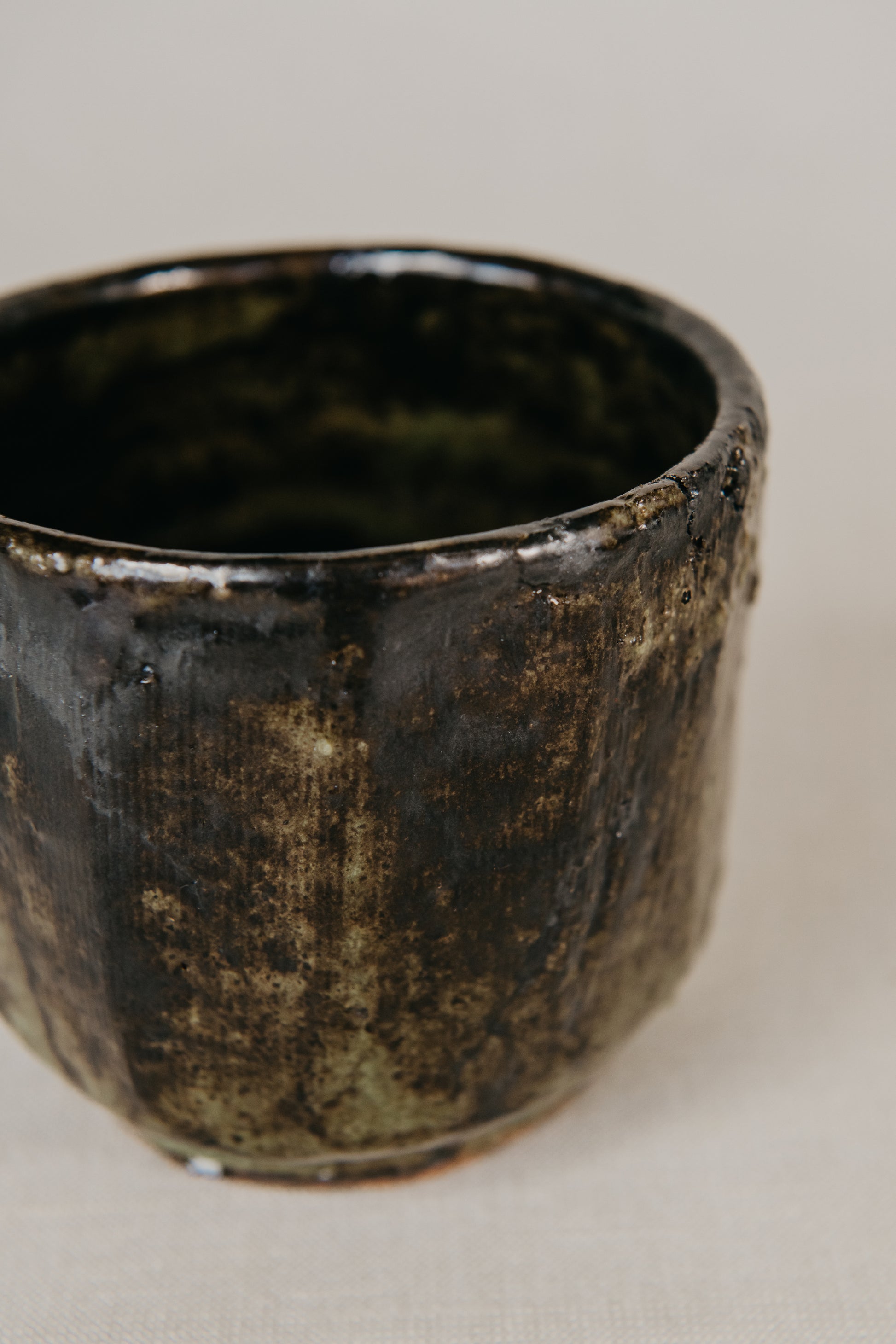 Black ceramic pot on a light background