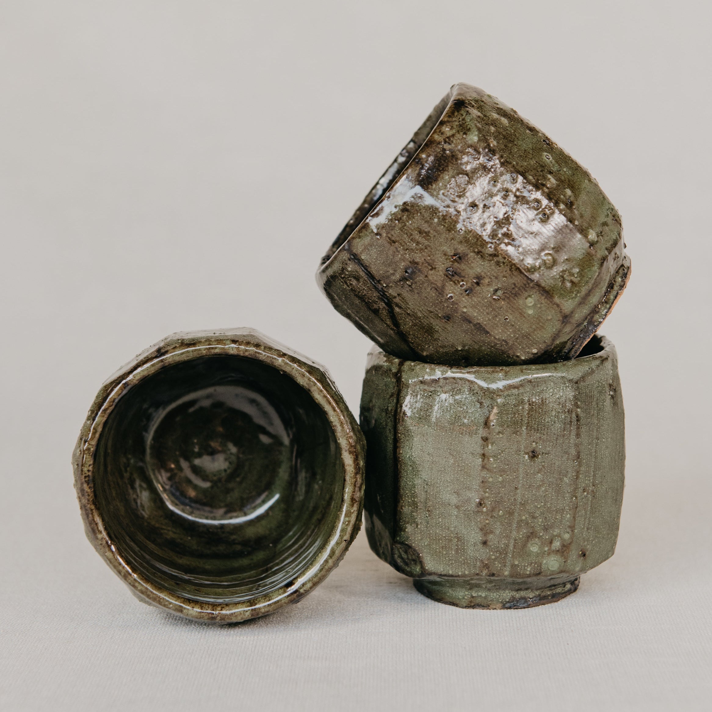 Close-up of a textured ceramic cups on a neutral background