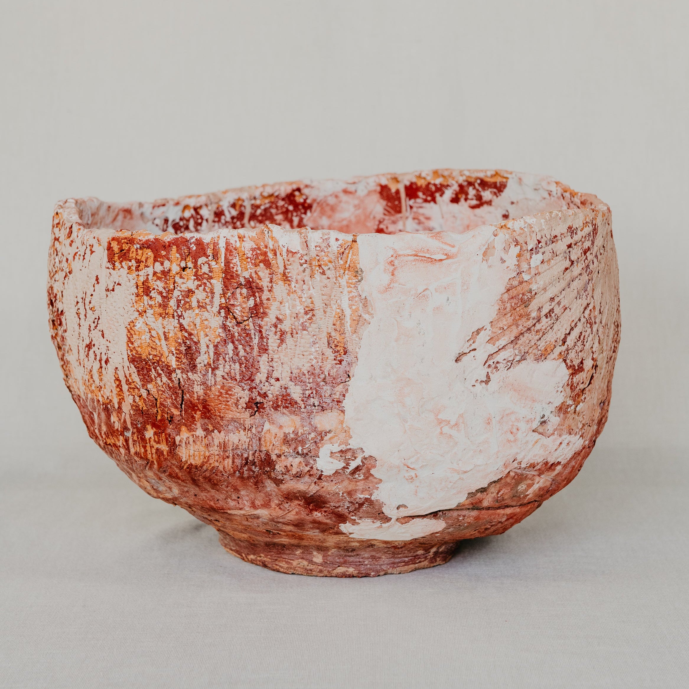Ceramic bowl with a textured surface on a plain background