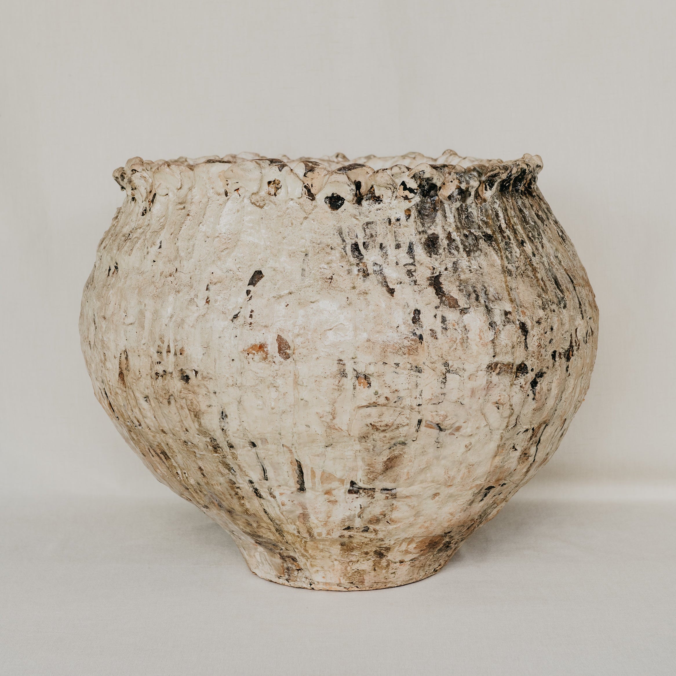 Textured ceramic pot on a plain background