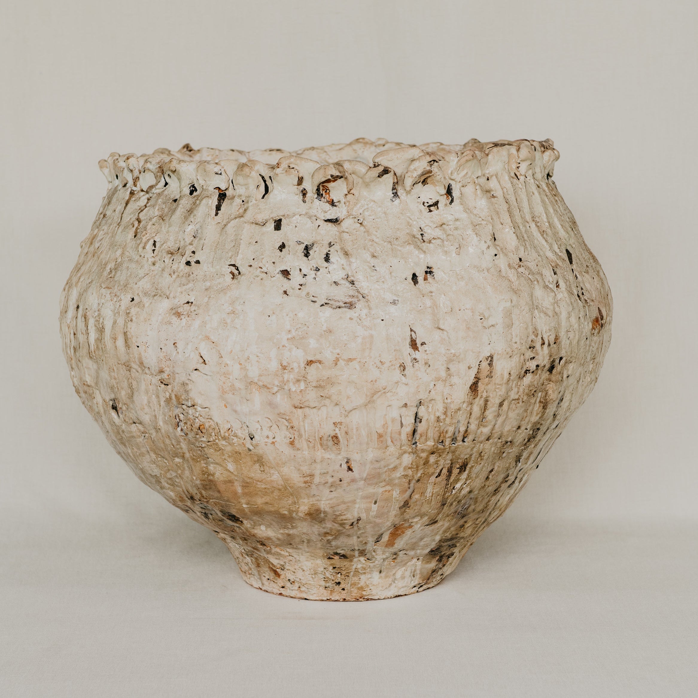 Rustic ceramic vase on a plain background