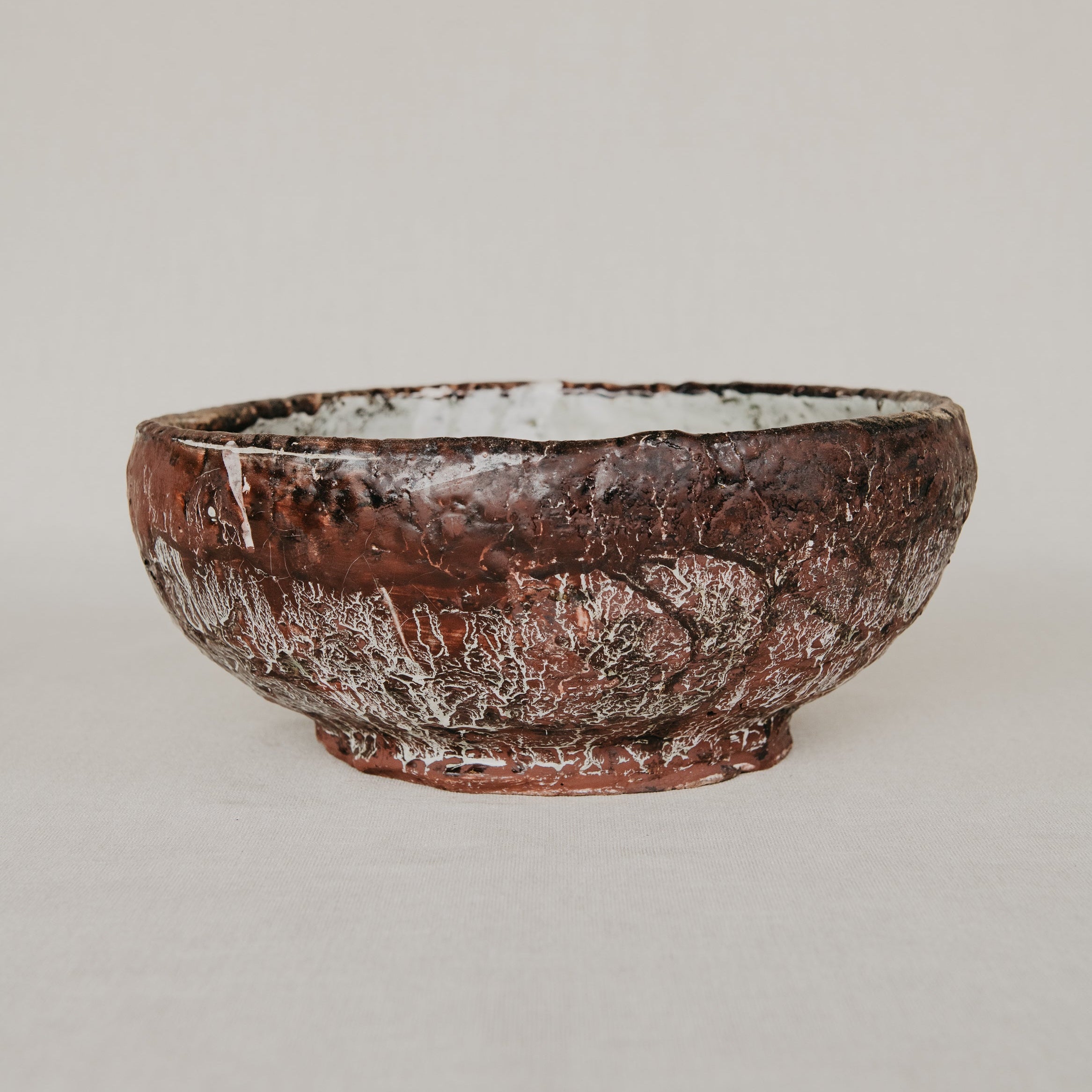 Brown ceramic bowl on a light gray background