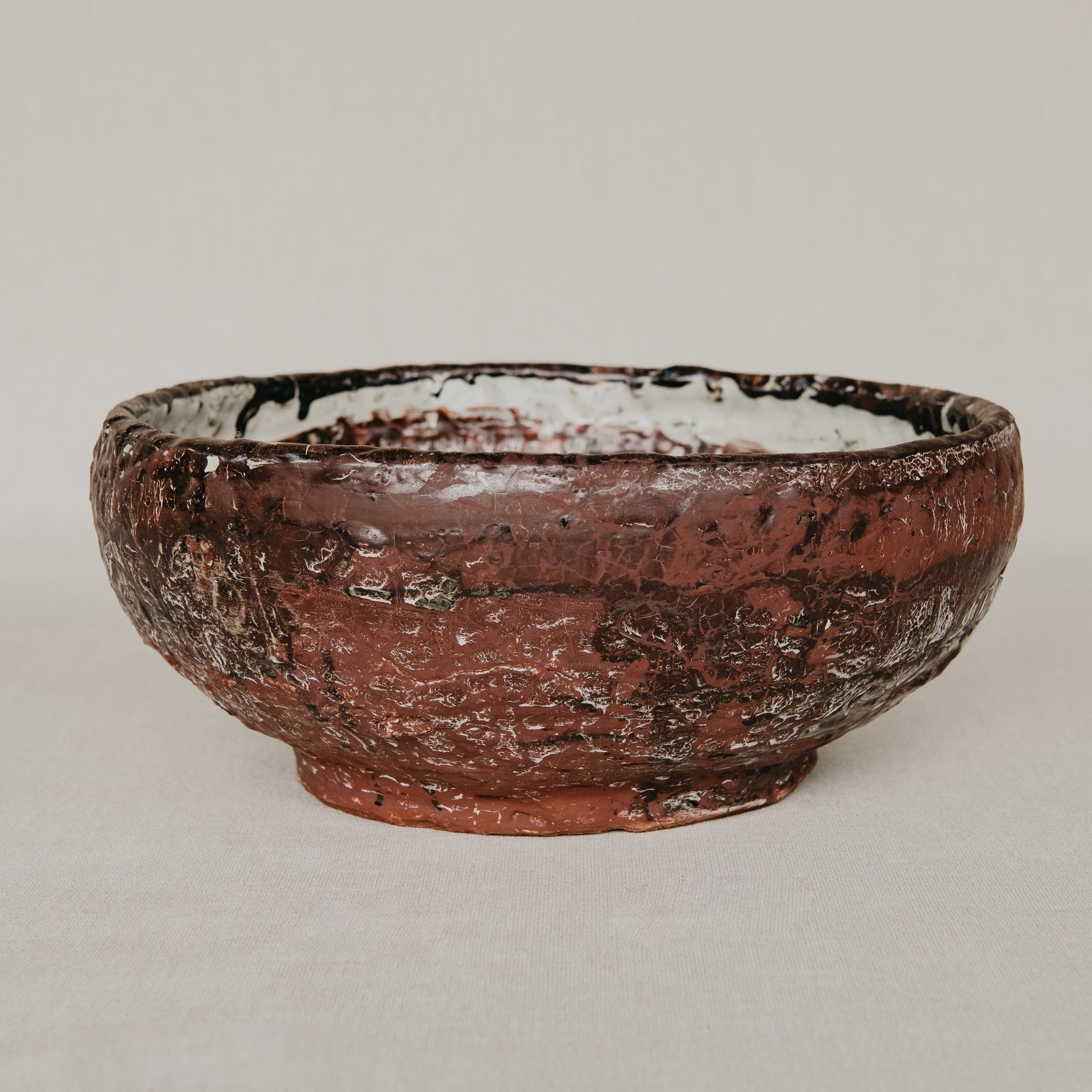 Ceramic bowl with textured surface on a plain background
