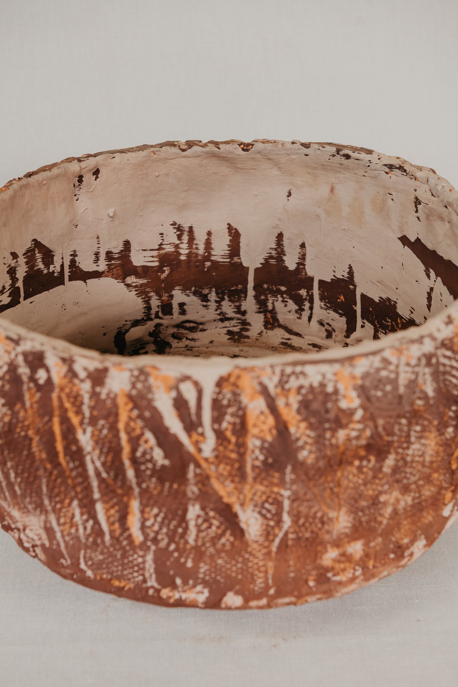 Textured ceramic bowl on a light gray background