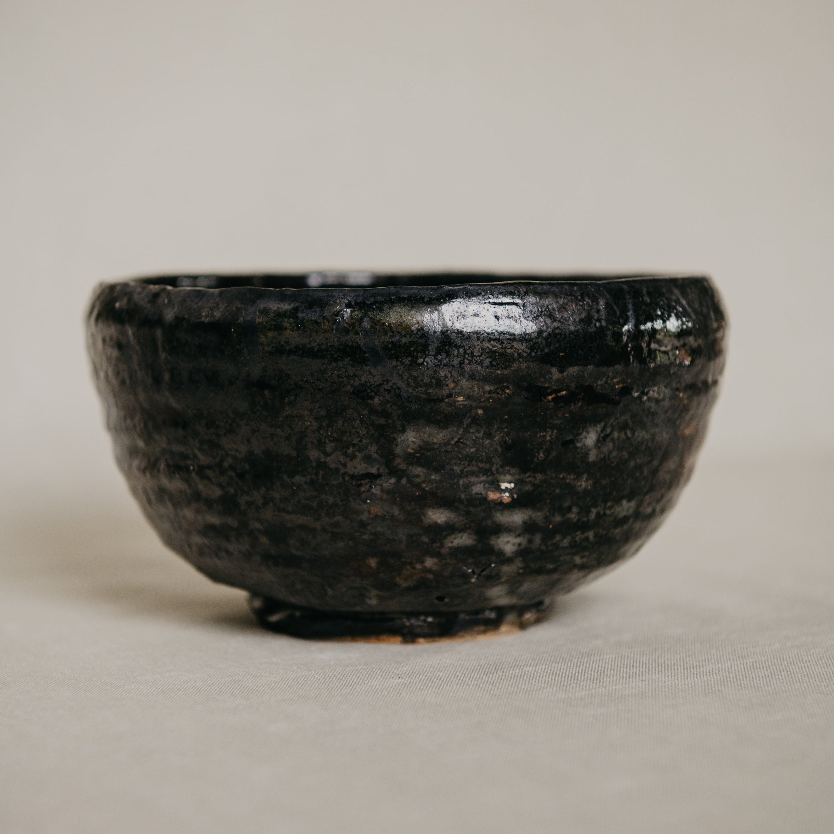 Black ceramic bowl on a plain background