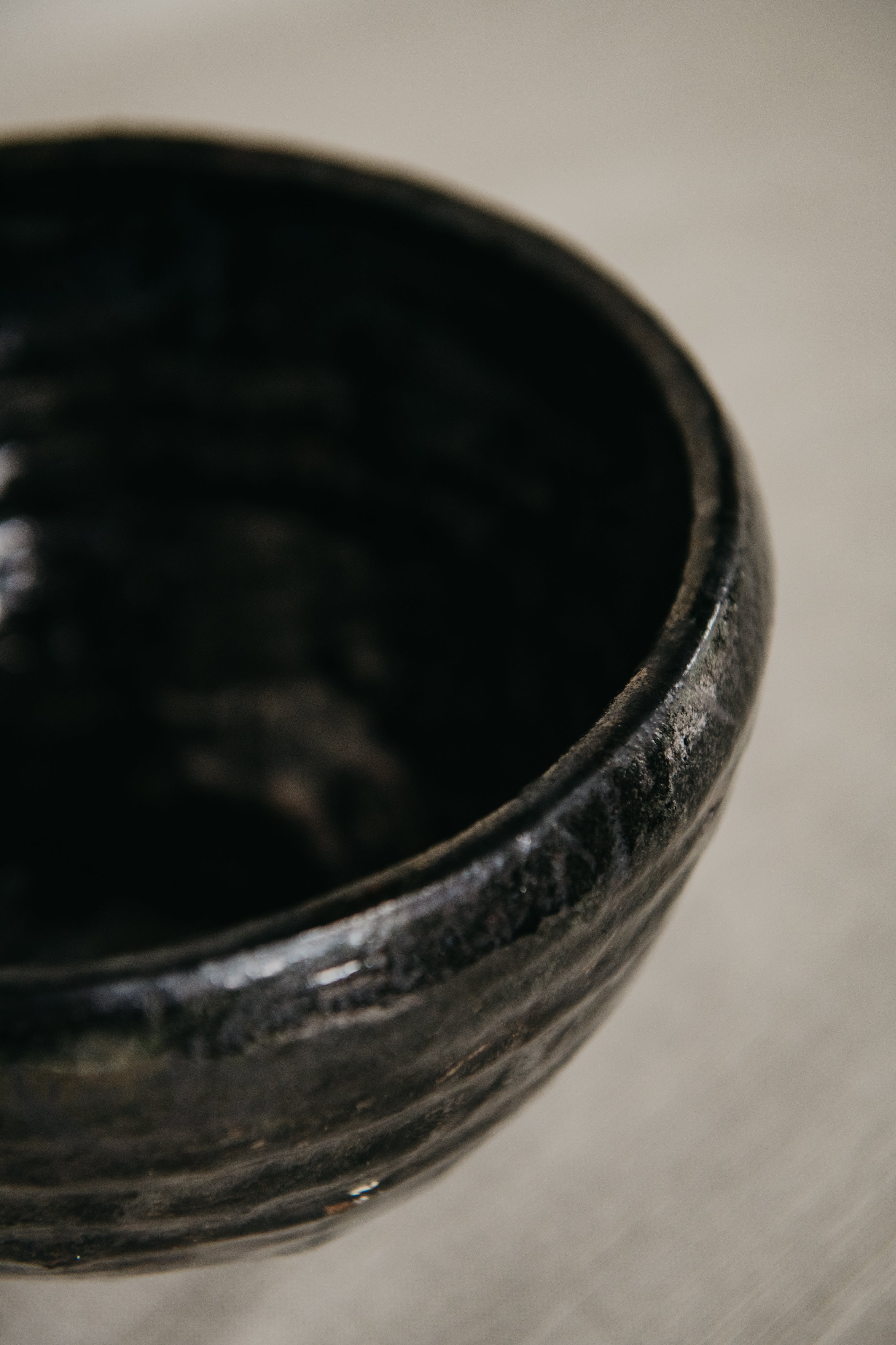 Black ceramic bowl on a neutral background