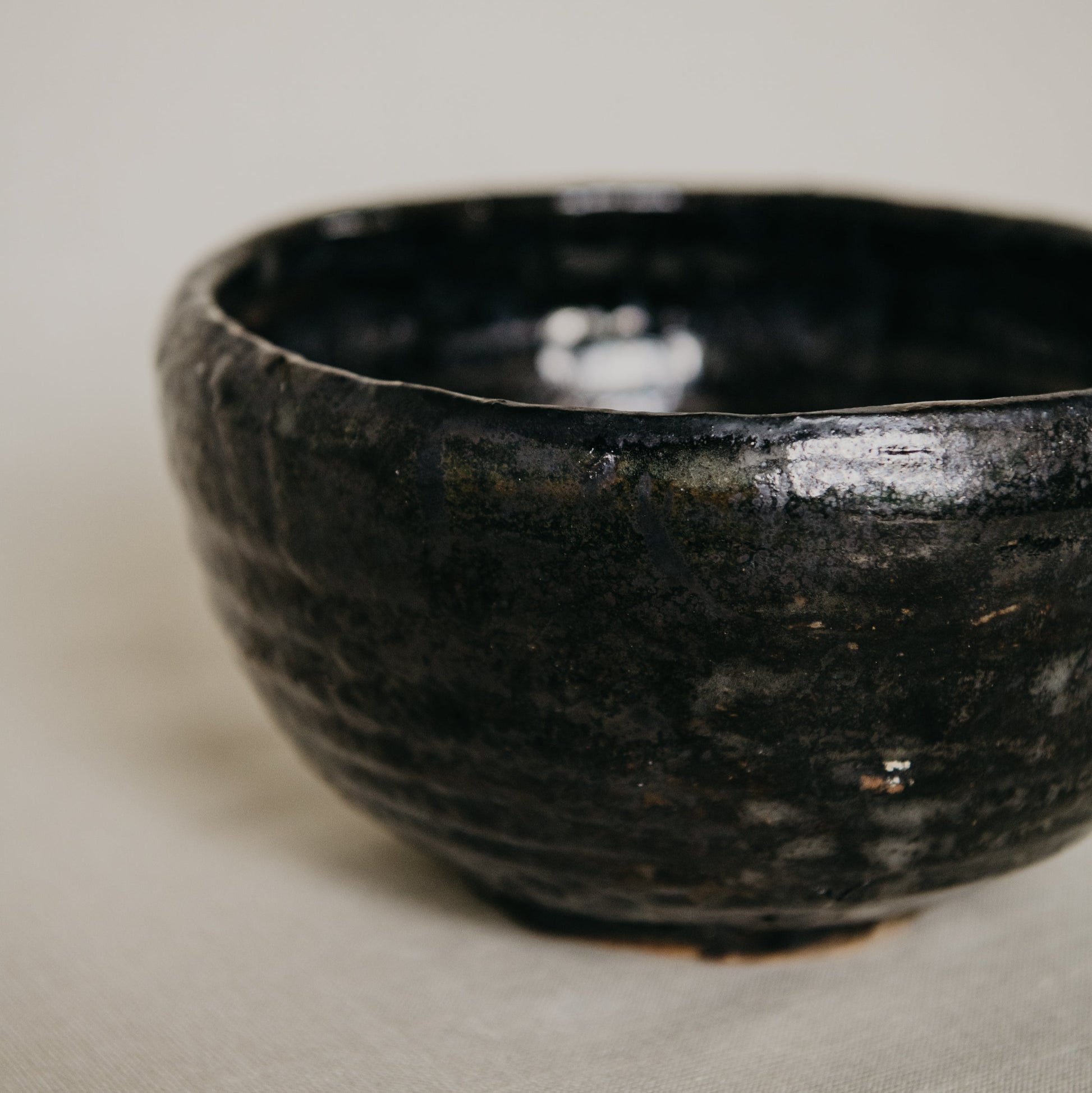 Black ceramic bowl on a beige surface