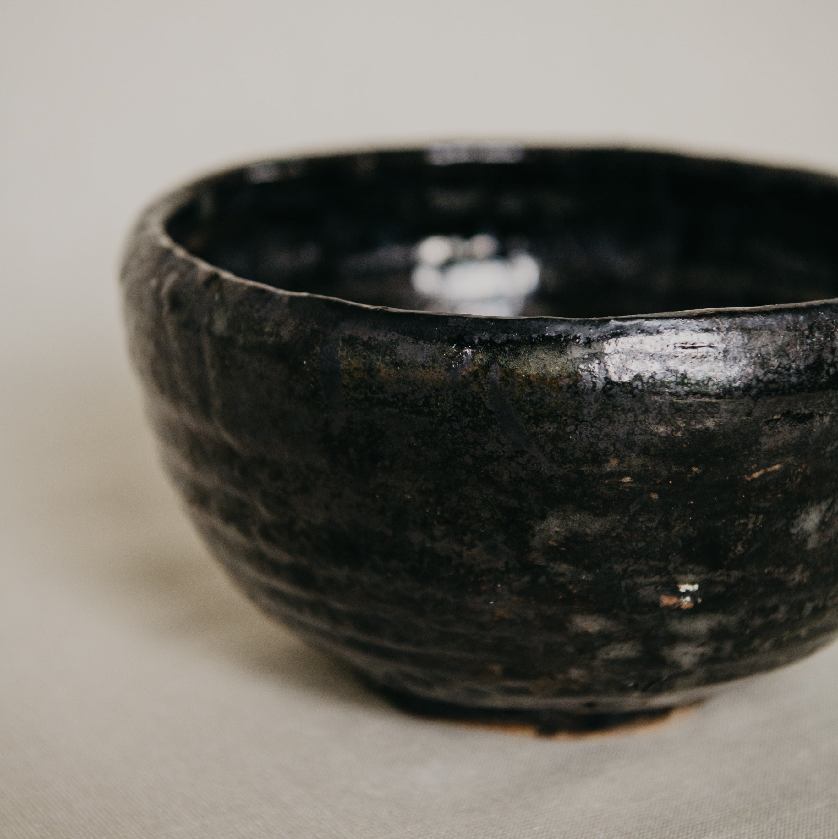 Black ceramic bowl on a beige surface