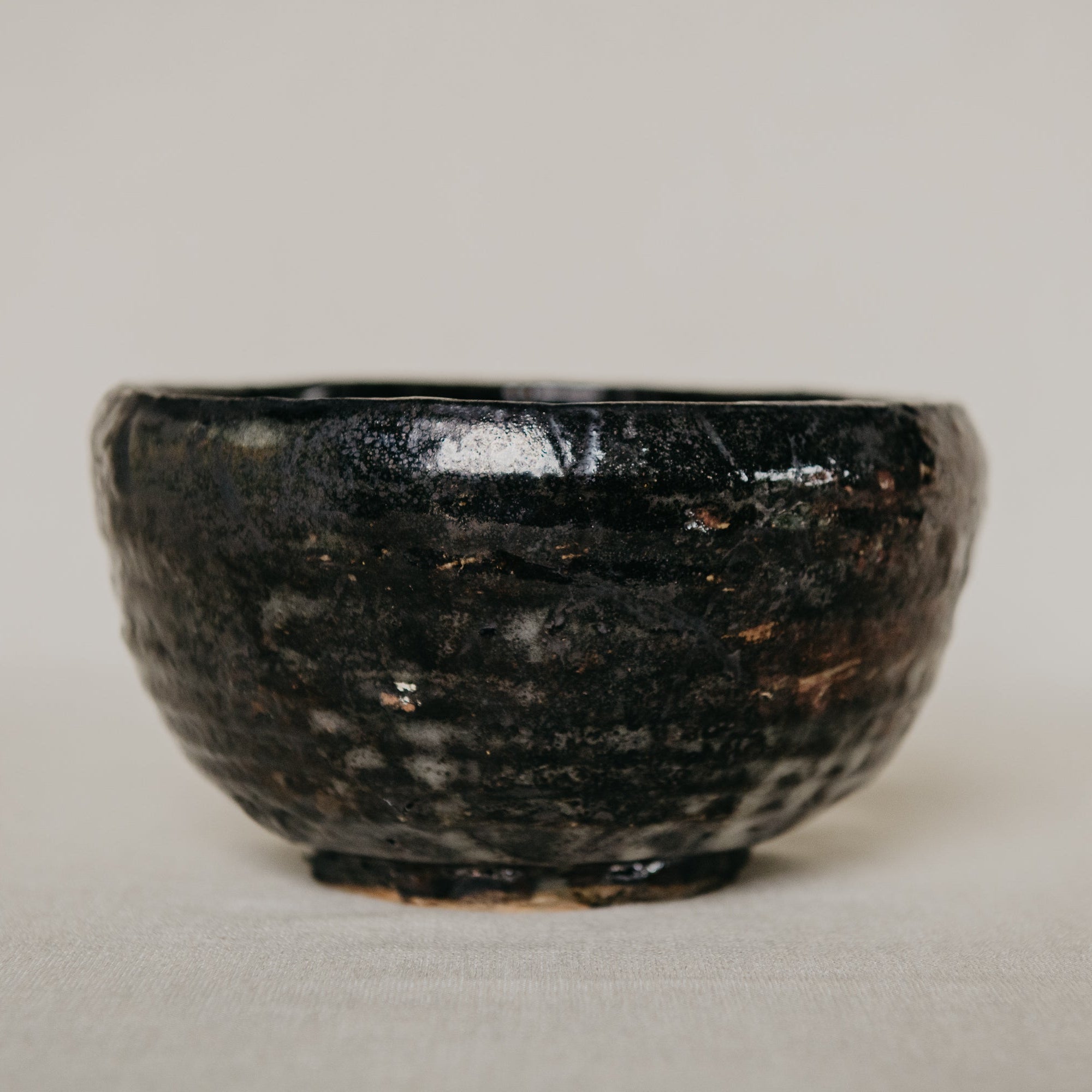 Black ceramic bowl on a light gray background