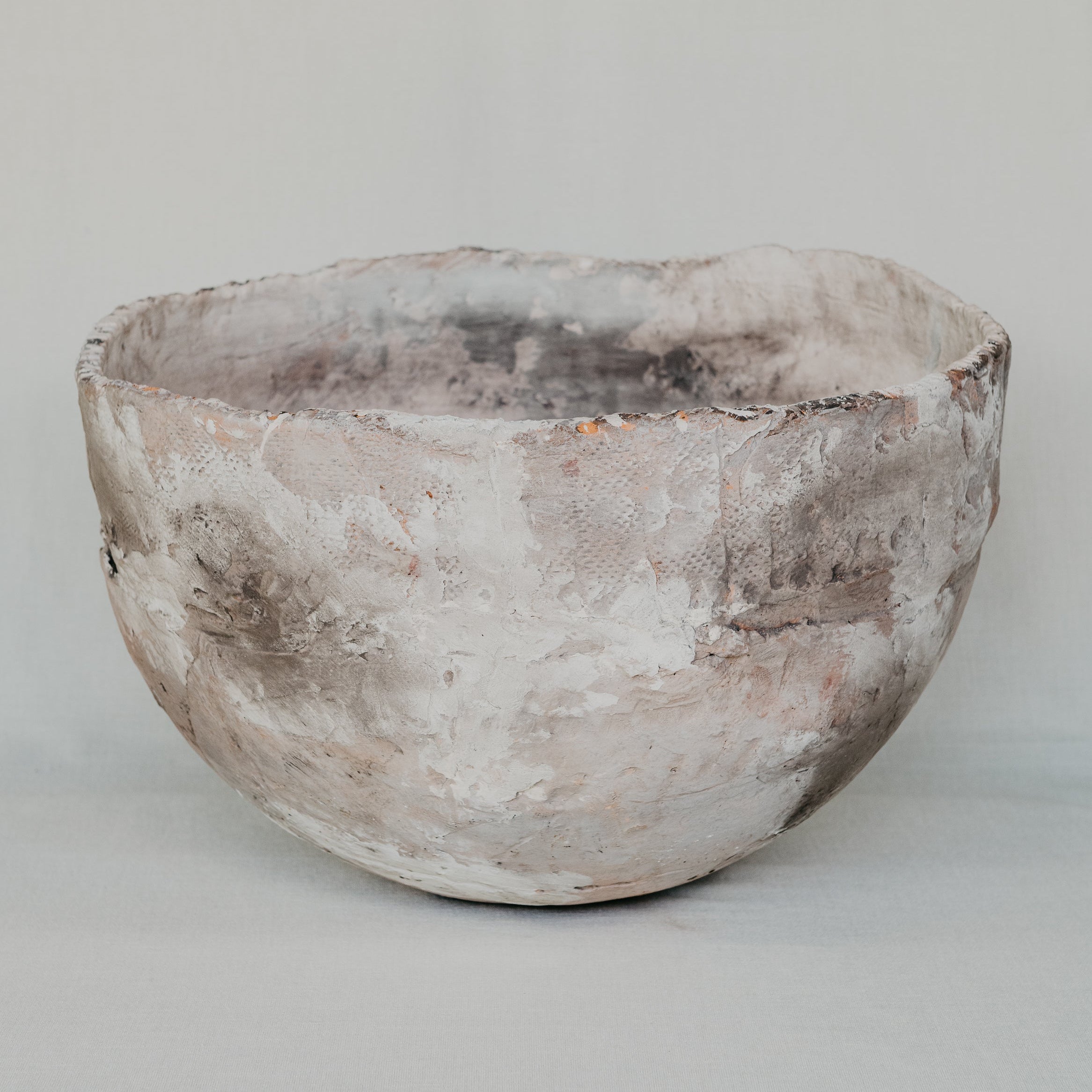 Vintage-style terracotta pot on a plain background