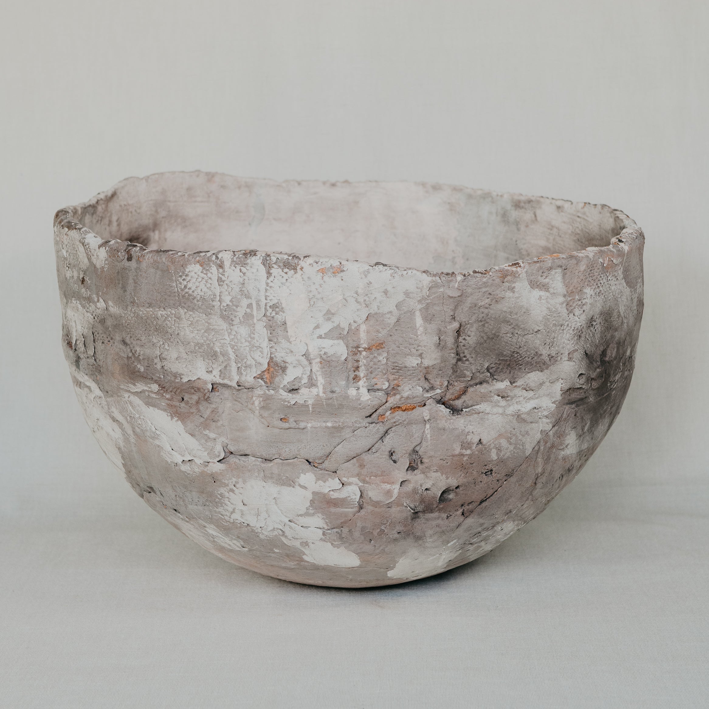 Textured ceramic bowl on a plain background