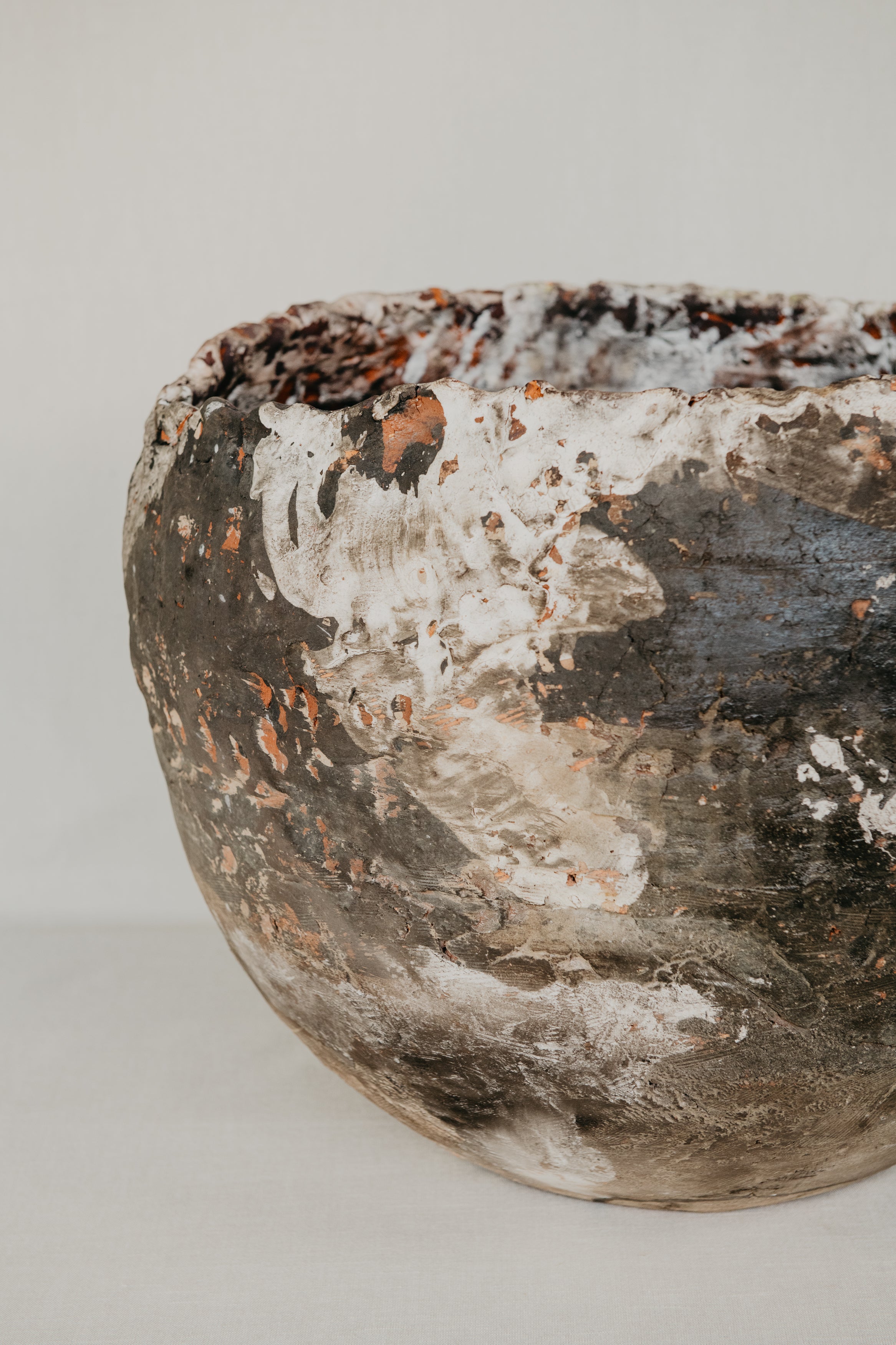 Vintage ceramic bowl with a textured surface on a plain background